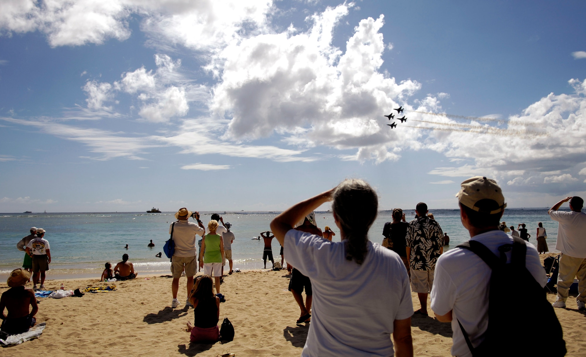 Spectators watch as the Air Force Thunderbirds demonstration team perform their aerial demonstration practice Sept. 13 in Waikiki, Hawaii. The Thunderbirds performed the practice session to prepare for their show Sept. 15 as part of Air Force Week Honolulu. (U.S. Air Force photo/Tech. Sgt. Shane A. Cuomo) 

