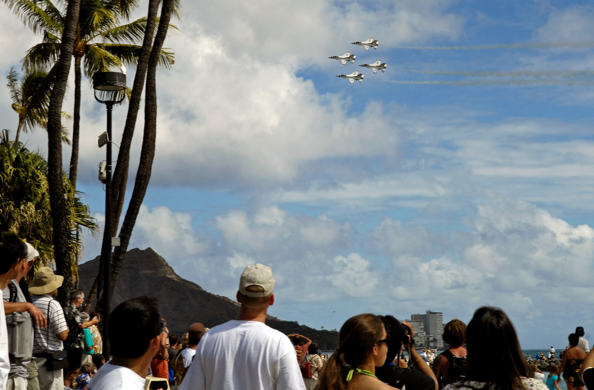 Spectators watch as the Air Force Thunderbirds demonstration team perform their aerial demonstration practice Sept. 13 in Waikiki, Hawaii. The Thunderbirds performed the practice session to prepare for their show Sept. 15 as part of Air Force Week Honolulu. (U.S. Air Force photo/Tech. Sgt. Shane A. Cuomo) 
