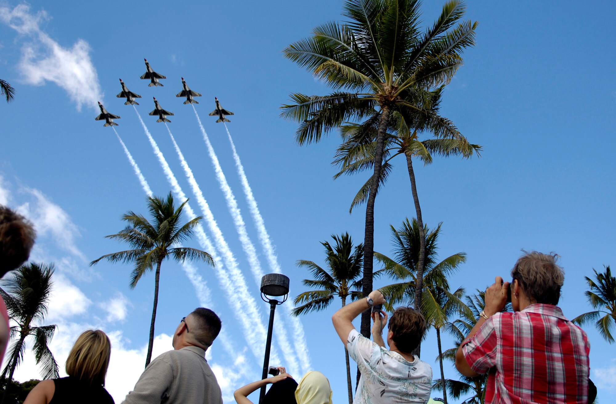 Spectators watch as the Air Force Thunderbirds demonstration team begin their aerial demonstration practice Sept. 13 in Waikiki, Hawaii. The Thunderbirds performed the practice session to prepare for their show Sept. 15 as part of Air Force Week Honolulu. (U.S. Air Force photo/Tech. Sgt. Shane A. Cuomo) 
