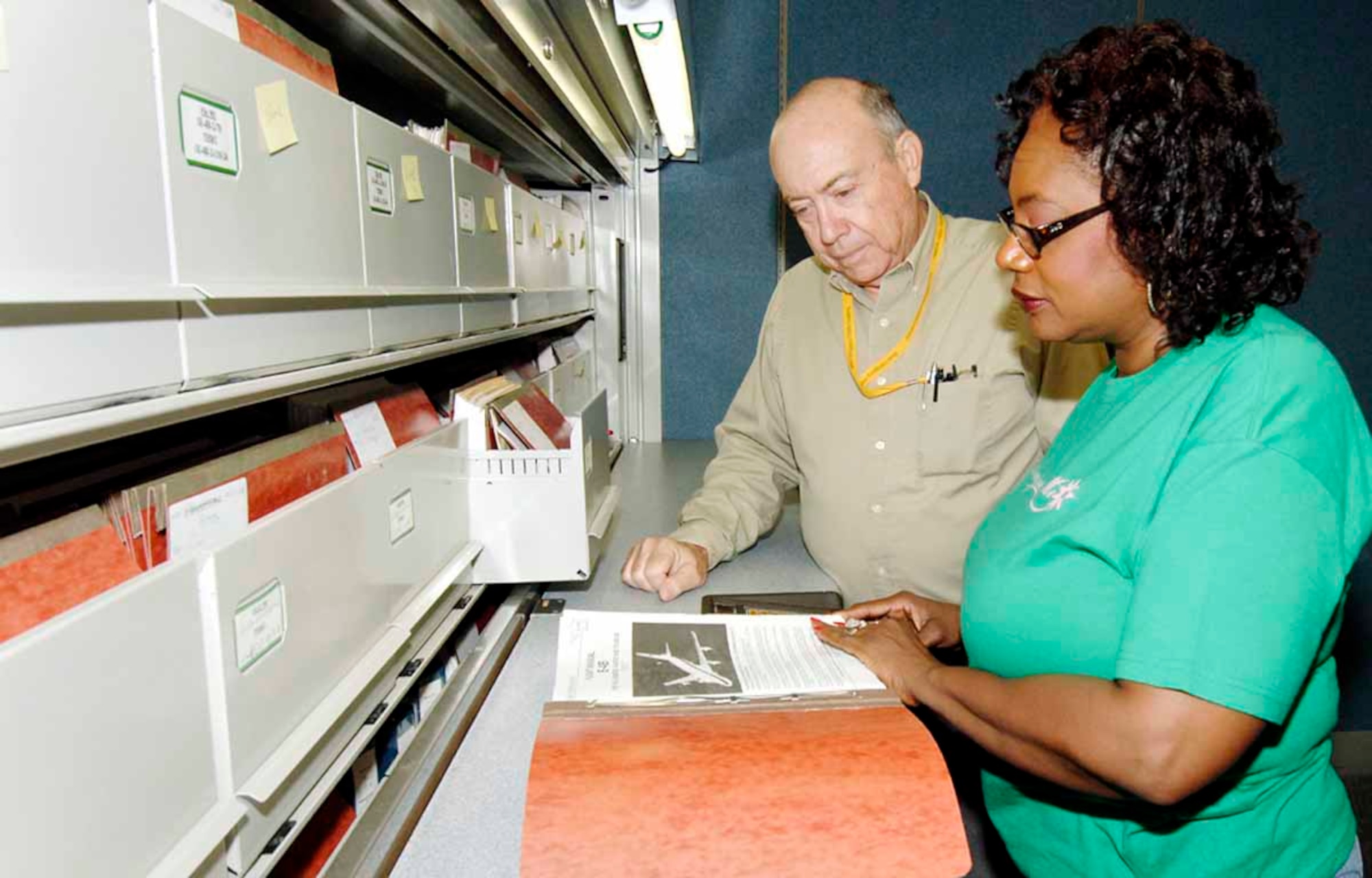 Beatrice Simpson, 558th CBSS lead clerk, and Haskell Kite, 558th CBSS file clerk, review a technical order at the paper-based Technical Order Library, which houses more than 12,000 paper-based TOs. (Air Force photo by Kirk McPheeters)