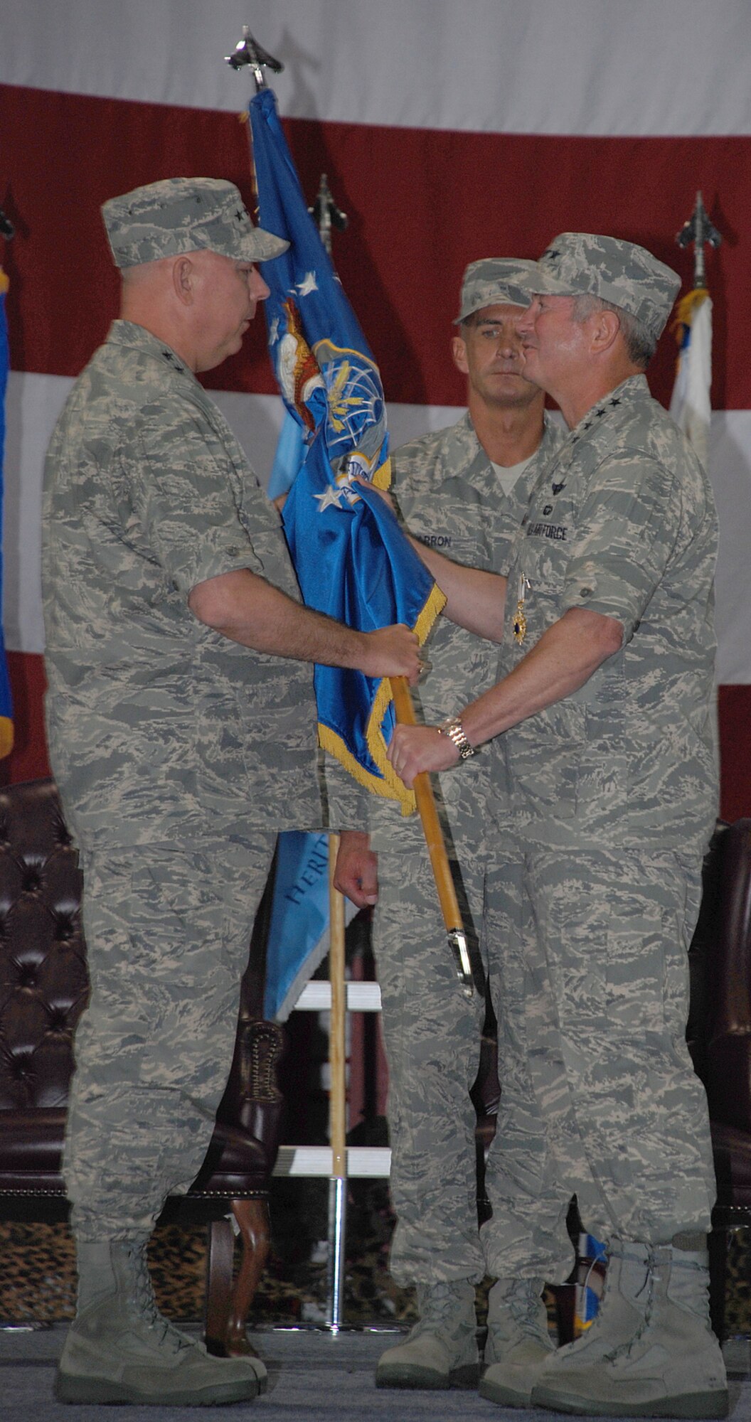 SCOTT AIR FORCE BASE, Ill. -- Gen. T. Michael Mosley, Air Force Chief of Staff, takes the Air Mobility Command guideon from General Duncan McNabb, AMC commander, at the AMC change of ceremony Sept 7. Gen McNabb will move on to be the Air Force vice chief of staff. (Photo by Airman 1st Class Jessica Lockoski)