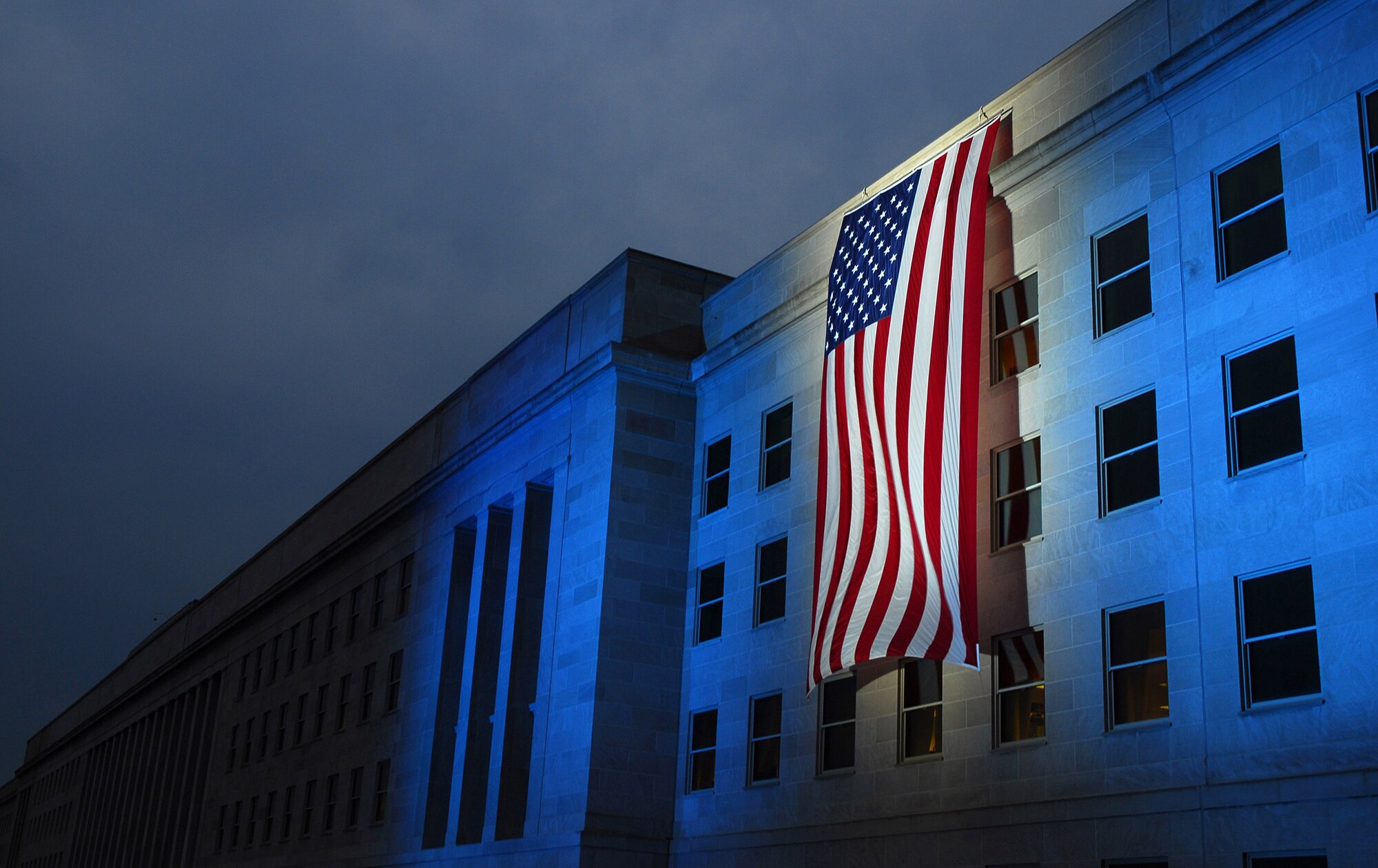 A memorial flag is illuminated near the spot where American Airlines Flight 77 crashed into the Pentagon on Sept. 11, 2001. (U.S. Navy photo/Petty Officer 1st Class Brandan W. Schulze) 