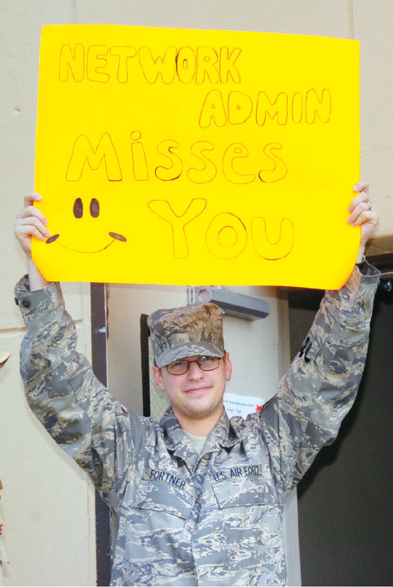 Senior Airman Eric E. Fortner displays a goodbye sign for his fellow Airmen from the 744th Communications Squadron. (US Air Force/Bobby Jones)