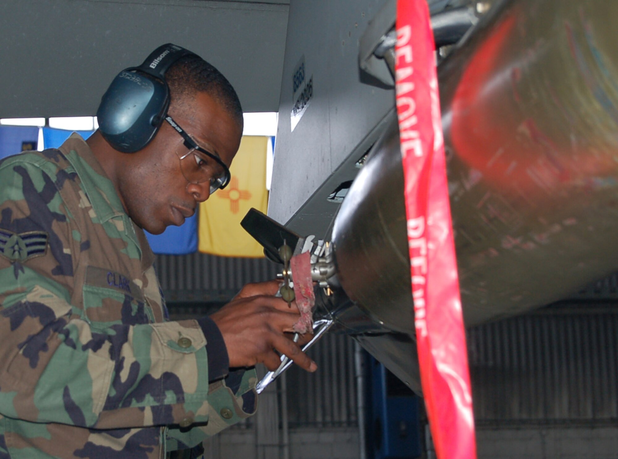 SPANGDAHLEM AIR BASE, Germany -- Senior Airman Damon Clark, 23rd Aircraft Maintenance Unit load crew, cuts the arming wire on an MK-82 low drag bomb during a weapons load competition Sept. 11. The 23rd AMU load crew won the competition. (U.S. Air Force photo/Staff Sgt. Tammie Moore)