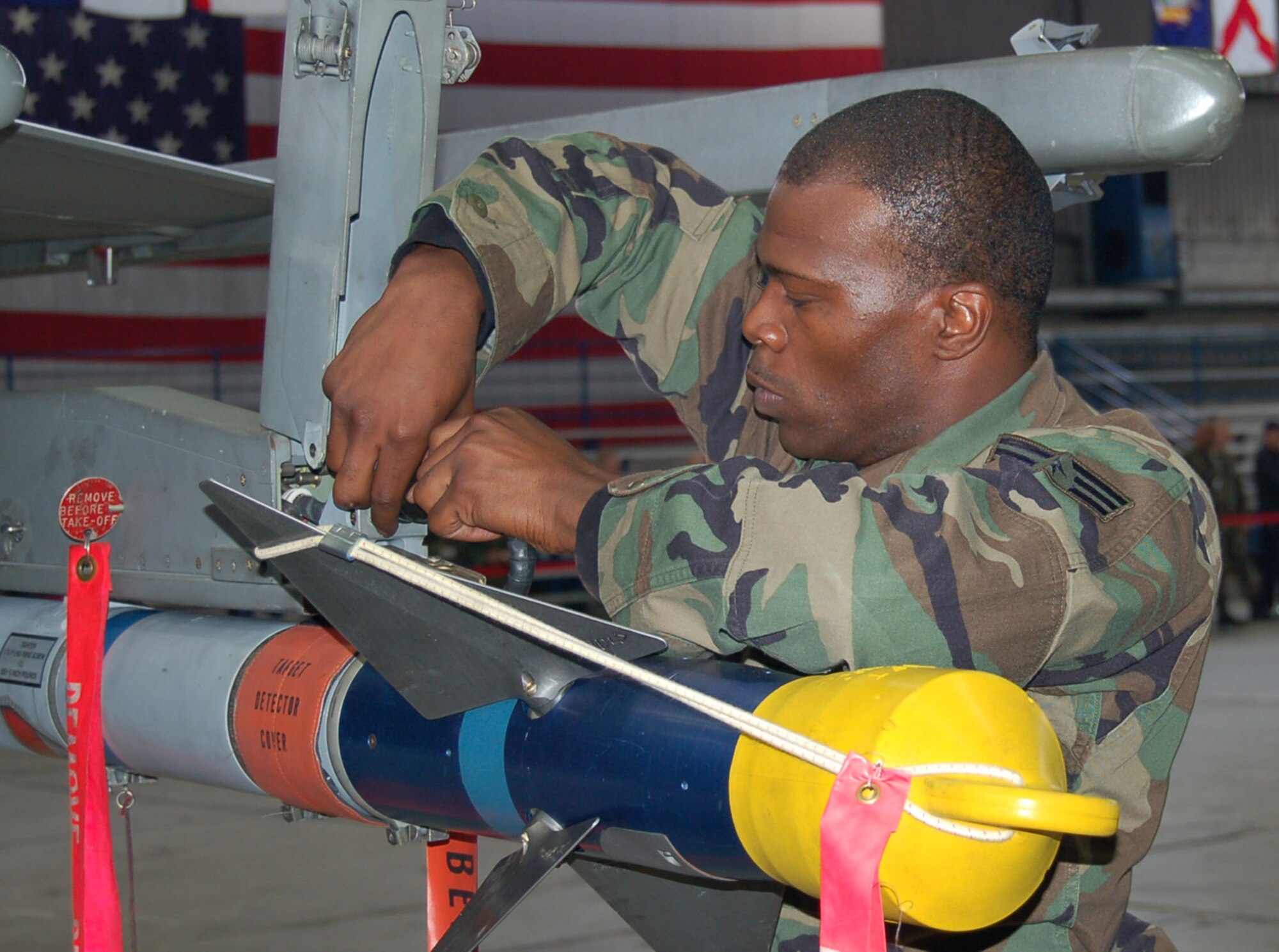 SPANGDAHLEM AIR BASE, Germany – Senior Airman Damon Clark, 23rd Aircraft Maintenance Unit load crew, secures an A1M 9 missile during a weapons load competition Sept. 11. The 23rd AMU load crew won the competition. (U.S. Air Force photo/Staff Sgt. Tammie Moore) 