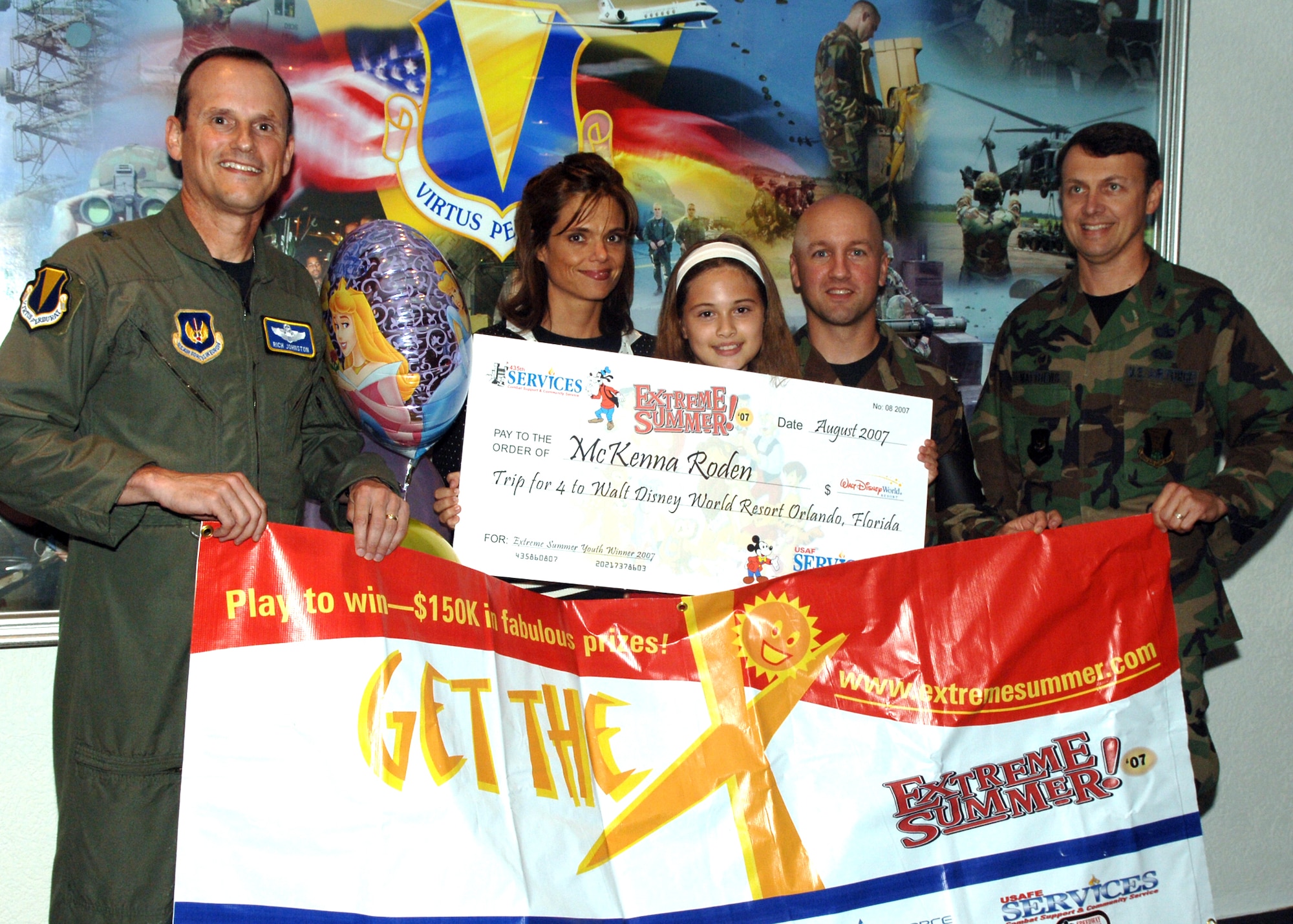 Brig. Gen. Rich Johnston, KMC and 86th Airlift Wing commander, left, and Col. Earl Matthews, 435th Air Base Wing commander, right, present one of U.S. Air Forces in Europe Services’ Extreme Summer Challenge prizes to winner McKenna Roden, center.(U.S. Air Force photo by Airman 1st Class Kelly LeGuilon)


