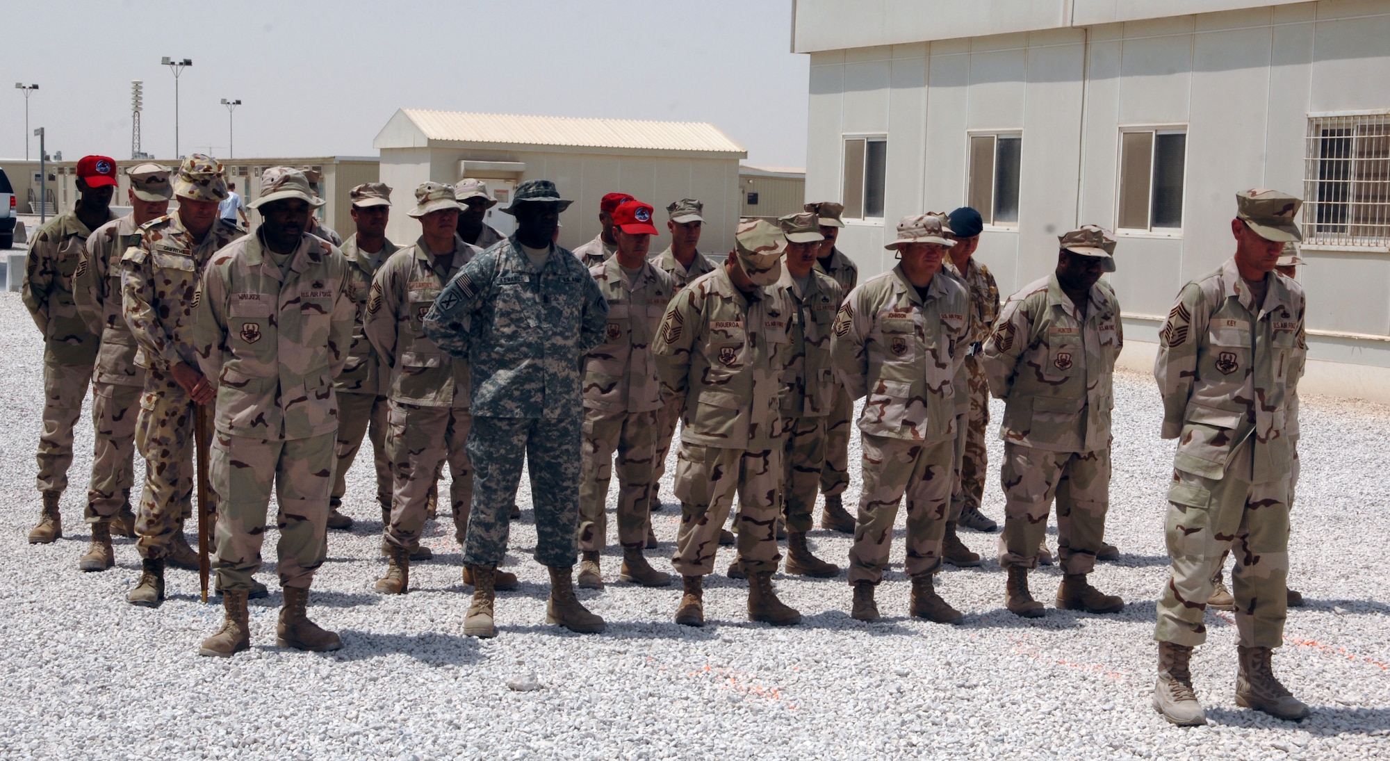 Coalition forces members attend to a moment of silence during a 9/11 memorial service at the 379th Air Expeditionary Wing on September 11, 2007.  The joint formation included members of the U. S. Air Force, U. S. Army, British Royal Air Force and Royal Australian Air Force all stationed in Southwest Asia supporting Operation Iraqi Freedom, Operation Enduring Freedom and Joint Task Force - Horn of Africa.  (U.S. Air Force Photo/MSgt Ken Stephens) 