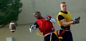 William Grimaldi, 1st Aircraft Maintenance Squadron, attempts an interception from Jason Renfroe , 1st Equipment Maintenance Squadron, during the intramural flag football game here Sept. 12. Despite 1st EMS’ hard work and big plays, Grimaldi and the 1st AMXS went on to win the game, 12-0. (U.S. Air Force photo/Airman 1st Class Vernon Young)