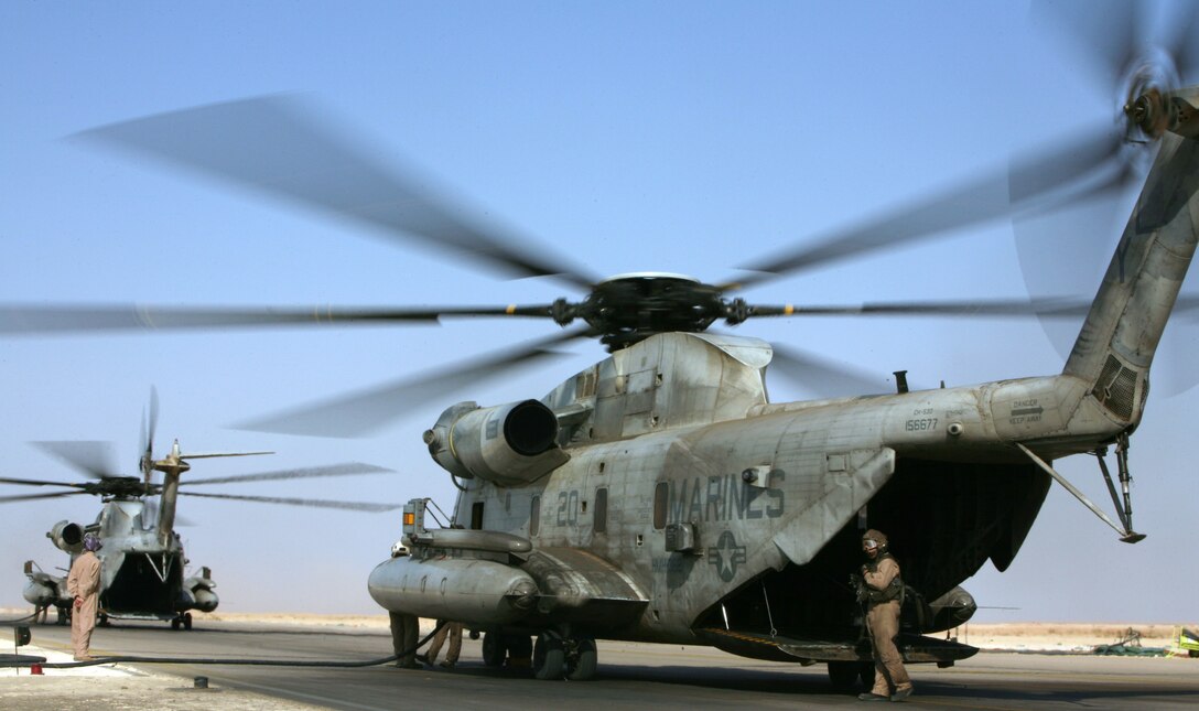 AL ASAD, Iraq - Two CH-53D "Sea Stallions" flown by Marine Heavy Helicopter Squadron 362 refuel at the Al Asad hot pits after a mission, Sept 15. The "Ugly Angels" have a history that reaches back 55 years and motivates the Marines to maintain the image of excellence created by the original members of the squadron.