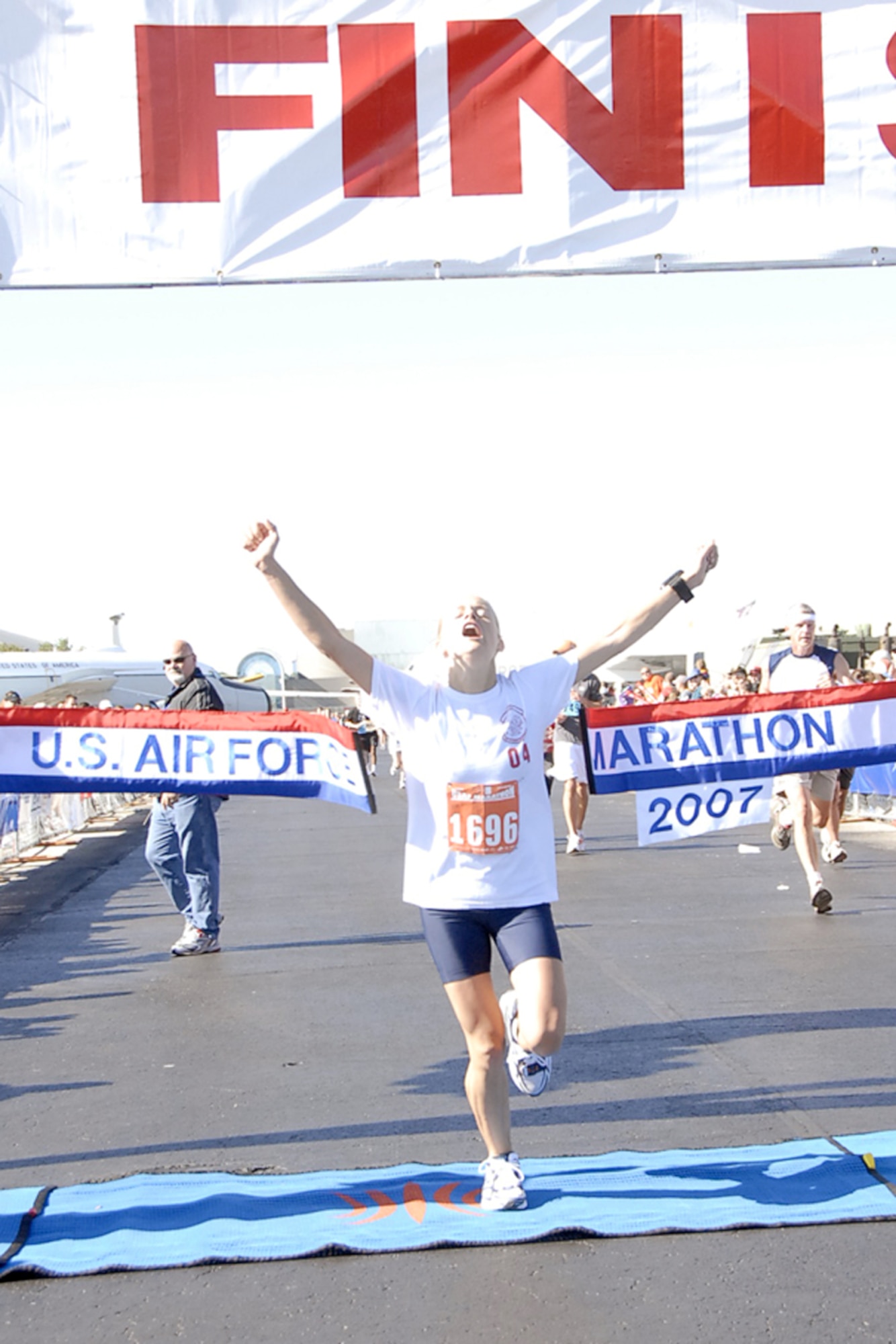2nd. Lt. Karissa Goodrich, from Goodfellow Air Force Base, Texas, celebrates her victory as the first overall female in the full marathon at Wright-Patterson Air Force Base, Ohio on Sept. 15.  Goodrich's official gun time was 3:06:54.  She was one of more than 6,300 runners in U.S. Air Force Marathon events. (Christy Webb/U.S. Air Force)