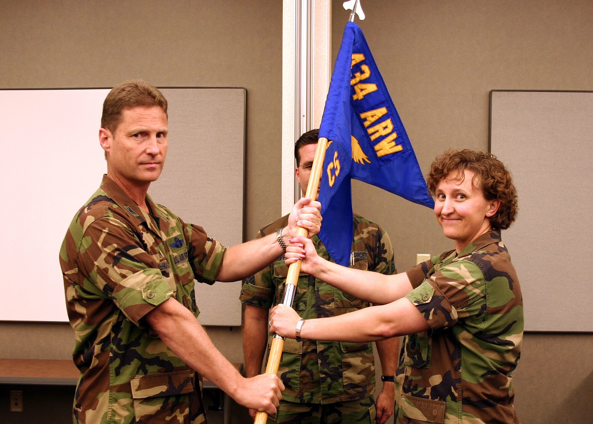 GRISSOM AIR RESERVE BASE, Ind., -- Maj. Rebecca Fox, takes the 434th Communications Squadron flag from Col. Doug McHugh, 434th Mission Support Group commander, as she assumes command during a ceremony held on the September unit training assembly. (U.S. Air Force photo/Tech. Sgt. Patrick Kuminecz)