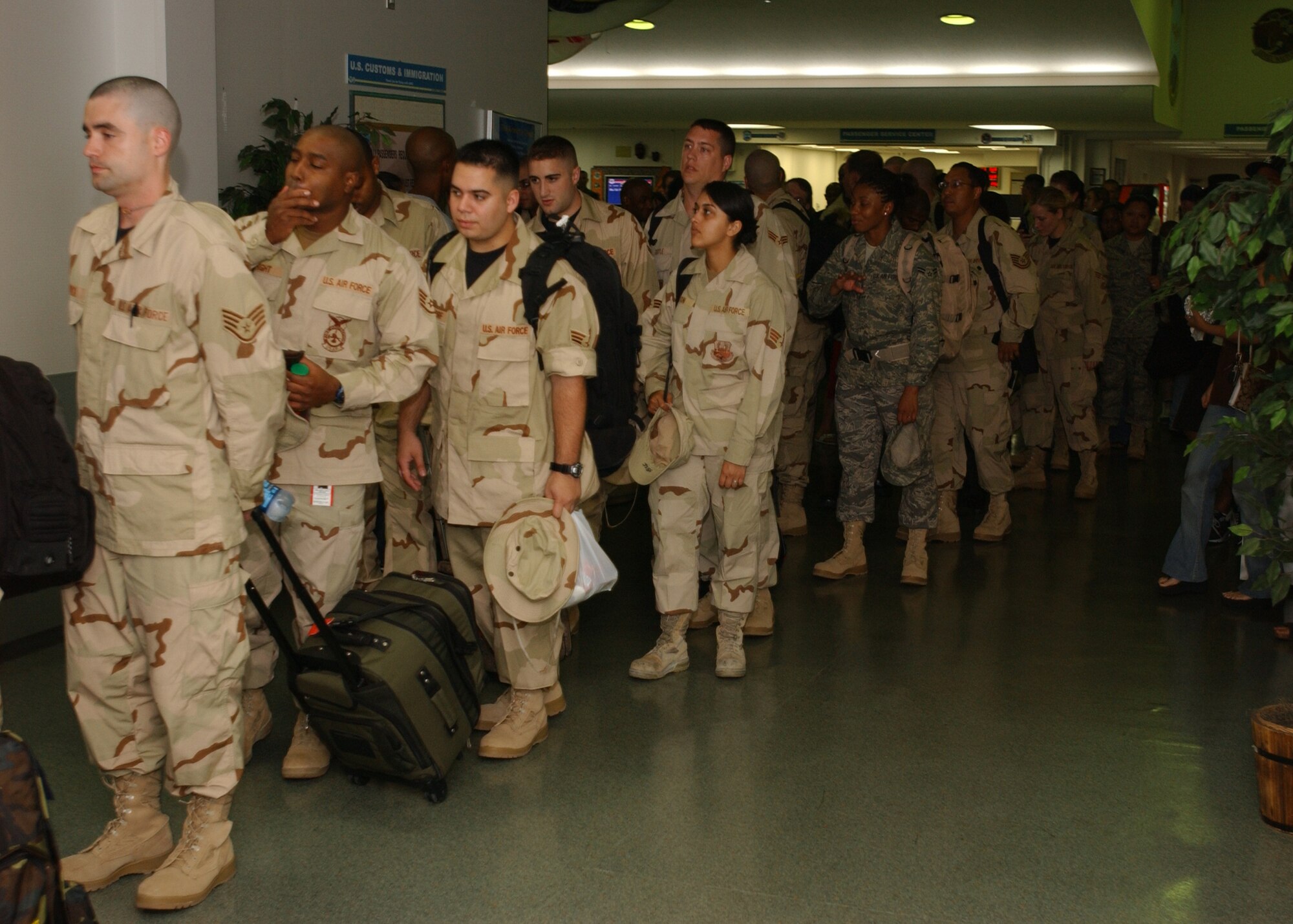 YOKOTA AIR BASE, Japan - Airmen from Yokota prepare to board their flight to leave for their deployments on September 15, 2007.  Approximately 75 Airmen are departing and are part of the second group of Airmen to deploy during the current Air Expeditionary Force rotation. (U.S. Air Force photo by Airman First Class Jonathan Fowler)