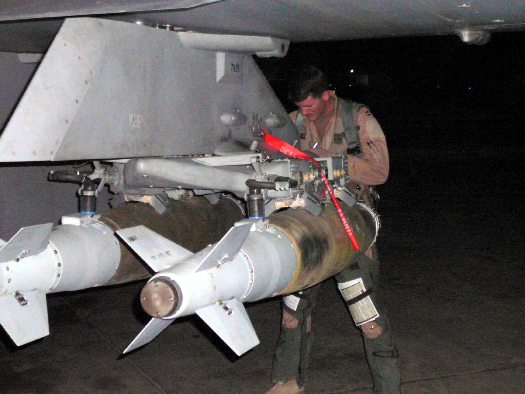 BALAD AIR BASE, Iraq -- Capt. Pete Schnobrich, 13th Expeditionary Fighter Squadron flight commander, preflights his GBU-38 Inertially Aided Munitions for a night sortie and his 100th combat mission in Operation Iraqi Freedom.  Captain Schnobrich previously flew OIF missions as part of the 421st EFS from Hill AFB in 2005. ((U.S. Air Force photo)
