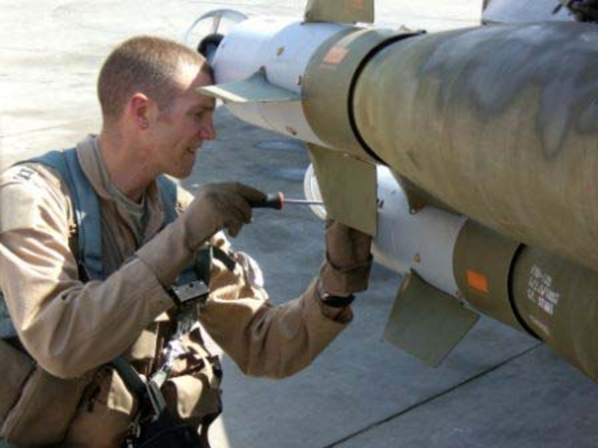 BALAD AIR BASE, Iraq -- Capt. "Cuda" Wolfard, 13th Expeditionary Fighter Squadron plans officer, sets the laser code to his GBU-12 Laser Guided Bombs on his 41st mission in Operation Iraqi Freedom.  Captain Wolfard's spouse, Capt. Krystal Wolfard, is also serving in OIF as a multinational corps as an Iraq Intelligence officer deployed to Baghdad. (U.S. Air Force photo)