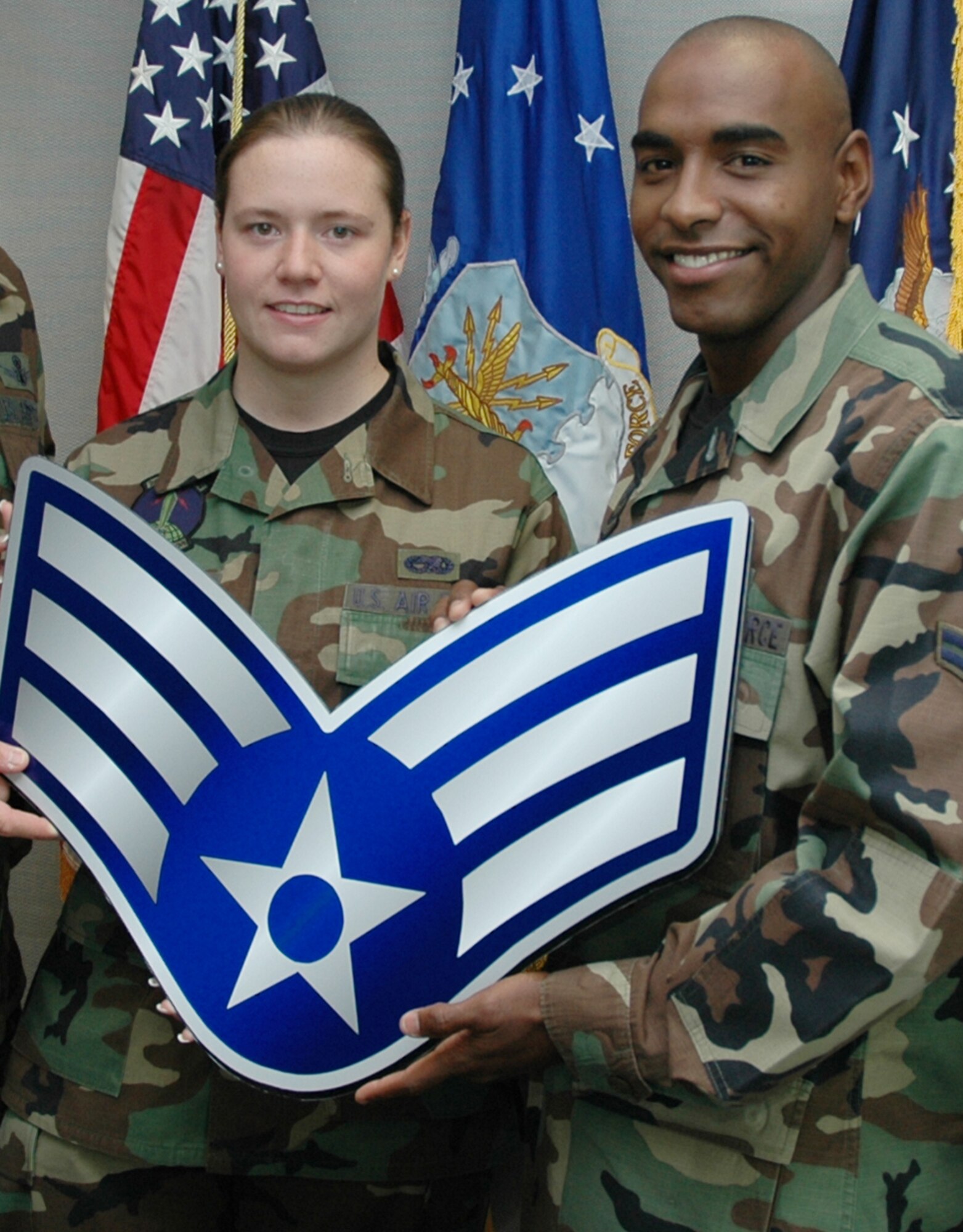 Three senior airmen were recently selected for below the zone promotions. They are: Airmen 1st Class Carley Demore (left), 21st Space Communications Squadron; Ricardo Wood, 21st Mission Support Squadron; and Paul Klar, 13th Air Support Operations Squadron (not pictured - PCSd). The Airmen received their additional stripe Sept. 17. There were 15 nominated for the BTZ Promotion Board, which met Sept. 11. (U.S. Air Force photo by Master Sgt. James Rush)