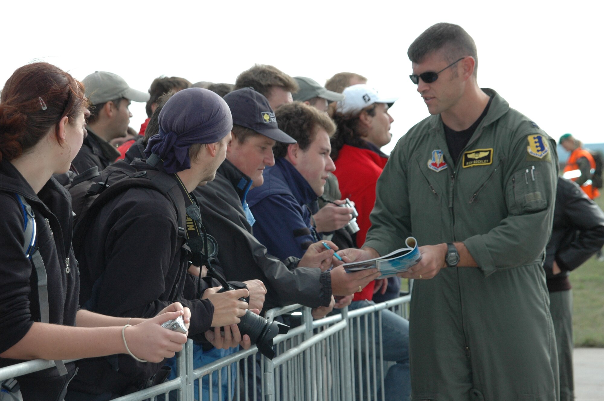 Capt. Richard Gockley, 37th Bomb Squadron co-pilot, signs autographs just after landing in the Czech Republic for the Czech Air Show Sept. 8. This was the first time a B-1 has landed in the Czech Republic; crowds lined up to meet the aircrew and take pictures of the jet. (U.S. Air Force photo/Airman 1st Class Kimberly Moore Limrick)