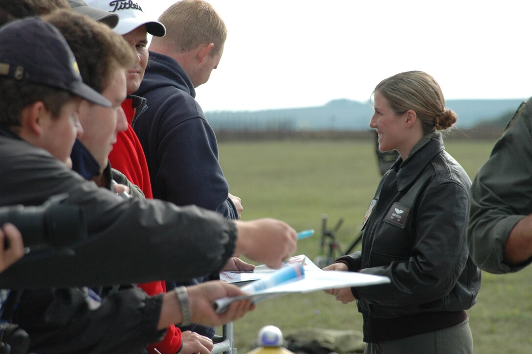 Capt. Robin Prosser, 37th Bomb Squadron weapons system officer, signs autographs just after landing in the Czech Republic for the Czech Air Show Sept. 8. This was the first time a B-1 has landed in the Czech Republic; crowds lined up to meet the aircrew and take pictures of the jet. (U.S. Air Force photo/Airman 1st Class Kimberly Moore Limrick)
