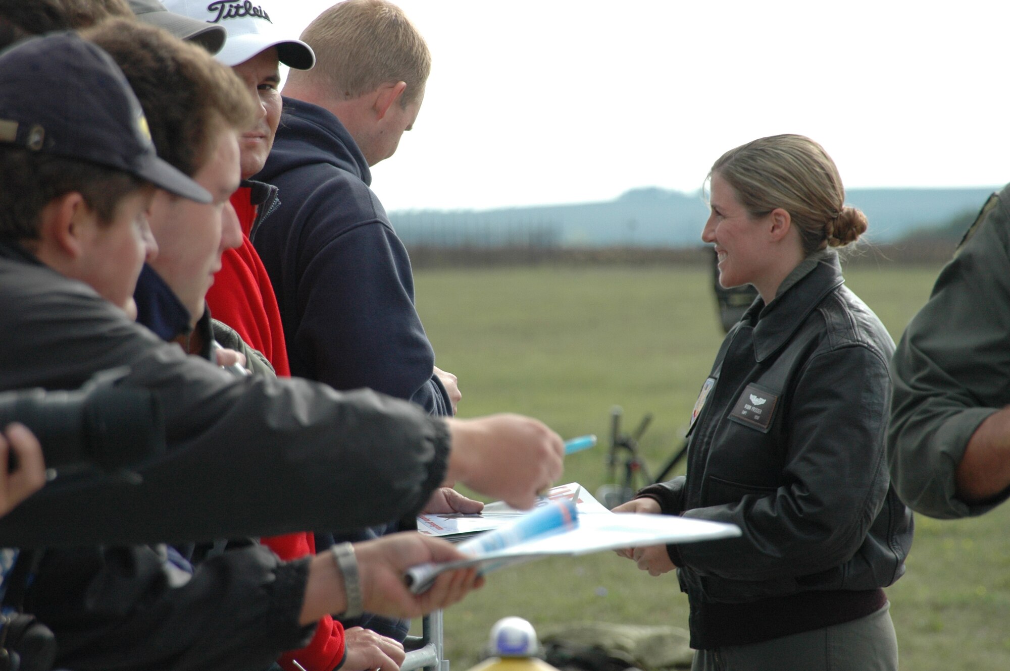Capt. Robin Prosser, 37th Bomb Squadron weapons system officer, signs autographs just after landing in the Czech Republic for the Czech Air Show Sept. 8. This was the first time a B-1 has landed in the Czech Republic; crowds lined up to meet the aircrew and take pictures of the jet. (U.S. Air Force photo/Airman 1st Class Kimberly Moore Limrick)
