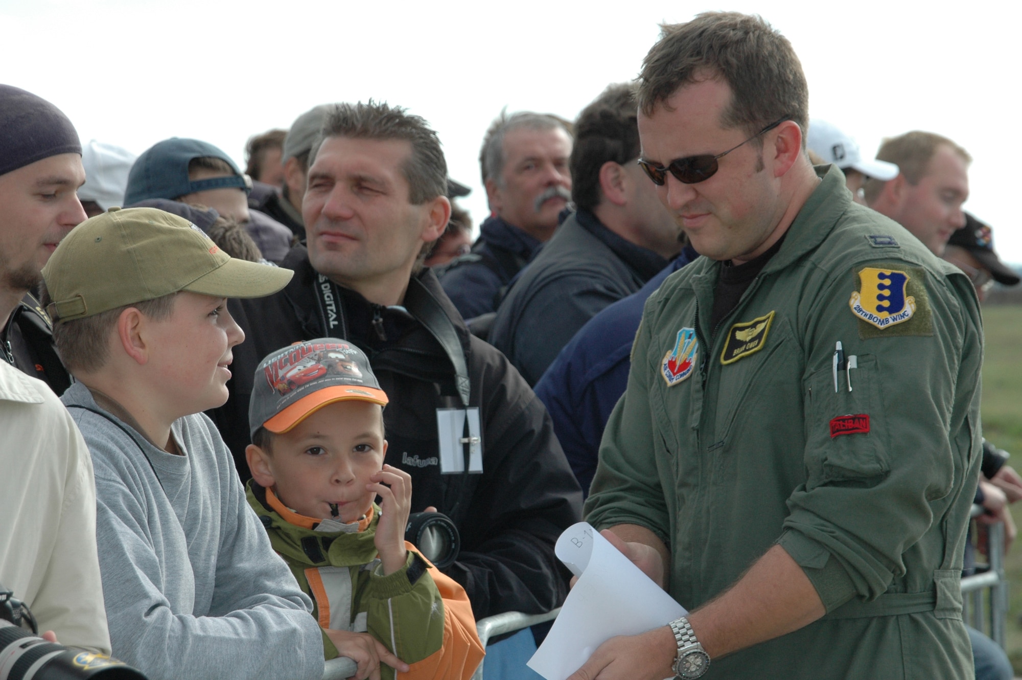 Capt. Brian Owen, 37th Bomb Squadron weapons system officer, signs autographs just after landing in Brno, Czech Republic, for the Czech Air Show Sept. 8. This was the first time a B-1 has landed in the Czech Republic; crowds lined up to meet the aircrew and take pictures of the jet. (U.S. Air Force photo/Airman 1st Class Kimberly Moore Limrick)

