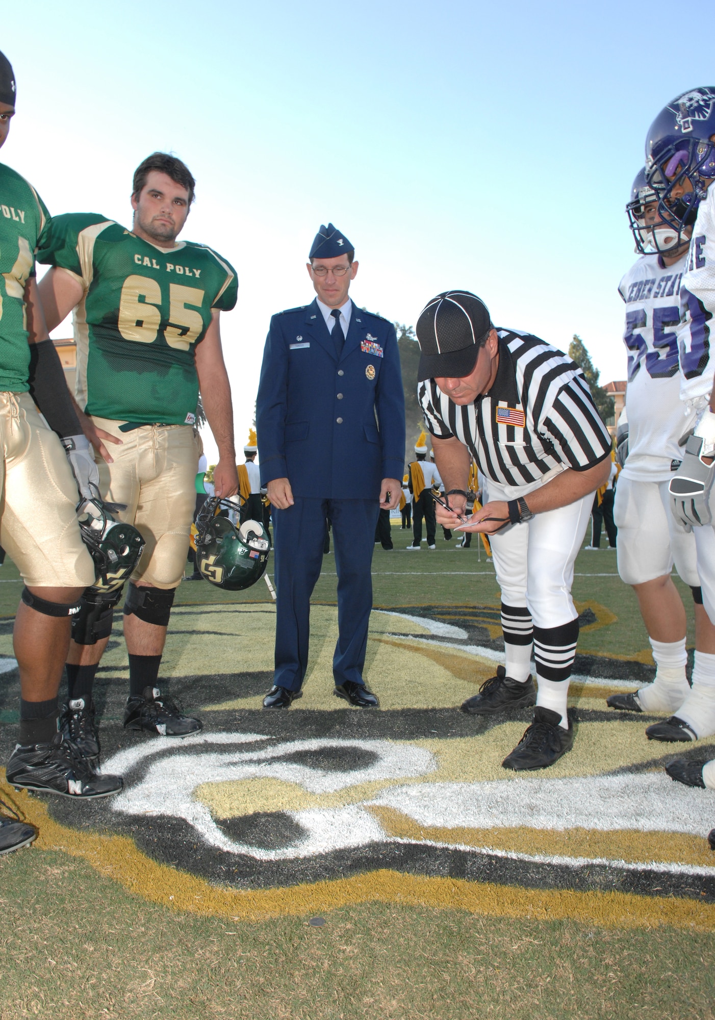 VANDENBERG AIR FORCE BASE, Calif. -- 30th Space Wing Commander Col. Steve Tanous observes the coin toss between Cal-Poly and Weber State players during the California Polytechnic State University military appreciation night on Sept. 15. The game and barbecue was available to military members. (U.S. Air Force photo/Staff Sgt. Vanessa Valentine)