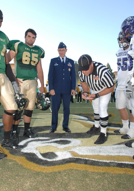 VANDENBERG AIR FORCE BASE, Calif. -- 30th Space Wing Commander Col. Steve Tanous observes the coin toss between Cal-Poly and Weber State players during the California Polytechnic State University military appreciation night on Sept. 15. The game and barbecue was available to military members. (U.S. Air Force photo/Staff Sgt. Vanessa Valentine)