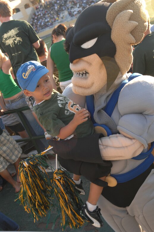 VANDENBERG AIR FORCE BASE, Calif. -- Vandenberg's mascot, Hawkman, holds his pal Kean Caldwell, 3, during the California Polytechnic State University military appreciation night on Sept. 15. The game and barbecue was available to military members. (U.S. Air Force photo/Staff Sgt. Vanessa Valentine)