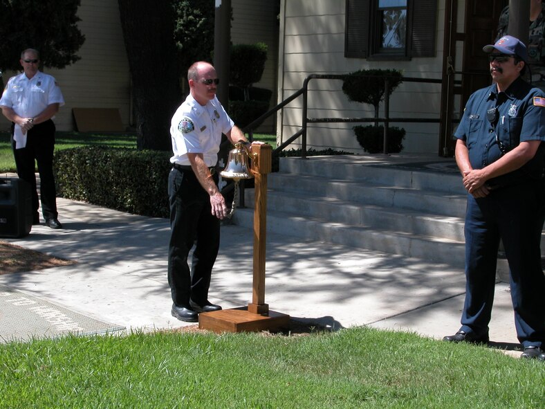 Assistant Fire Chief Eliot Cooper, 452nd AMW, rings the bell in honor of the many firefighters who sacrificed their lives on 9/11. (U.S. Air Force photo by LaGina Jackson)