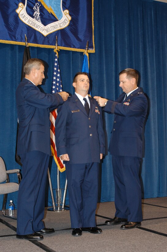 PITTSBURGH AIR RESERVE STATION, Pa -- Brig. Gen. Richard Severson, Deputy Vice Commander of AFRC and Maj. Gen. Tod M. Bunting, Adjutant General of Kansas and guest speaker at the event, pin newly commissioned 2nd Lt. Shawn M. Walleck of the 911th Airlift Wing, Air Force Reserve Command, Pittsburgh, Pa.  Lt. Walleck was the 996th reservist to complete the six-week program at the Academy of Military Science, McGhee Tyson Air National Guard Base, Tenn. (AF photo by Master Sgt. Mark Winklosky)
                                