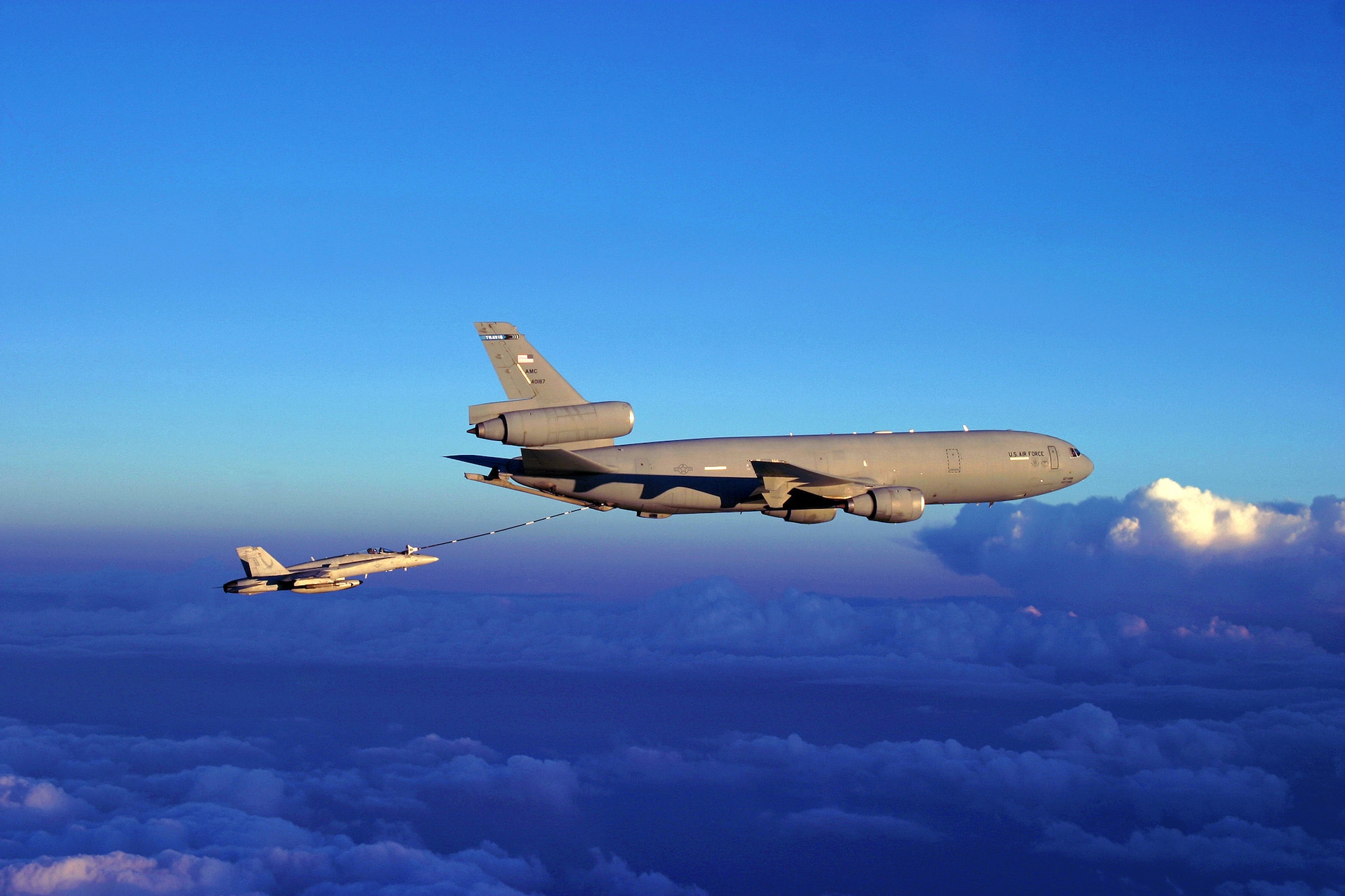 A Navy F/A-18 Hornet fighter receives fuel from a KC-10 Extender over Afghanistan.  On Sept. 15, coalition tankers flew 46 sorties and off-loaded approximately 2.4 million pounds of fuel to 210 receiving aircraft.  (DOD photo/Navy Lt. Peter Scheu)