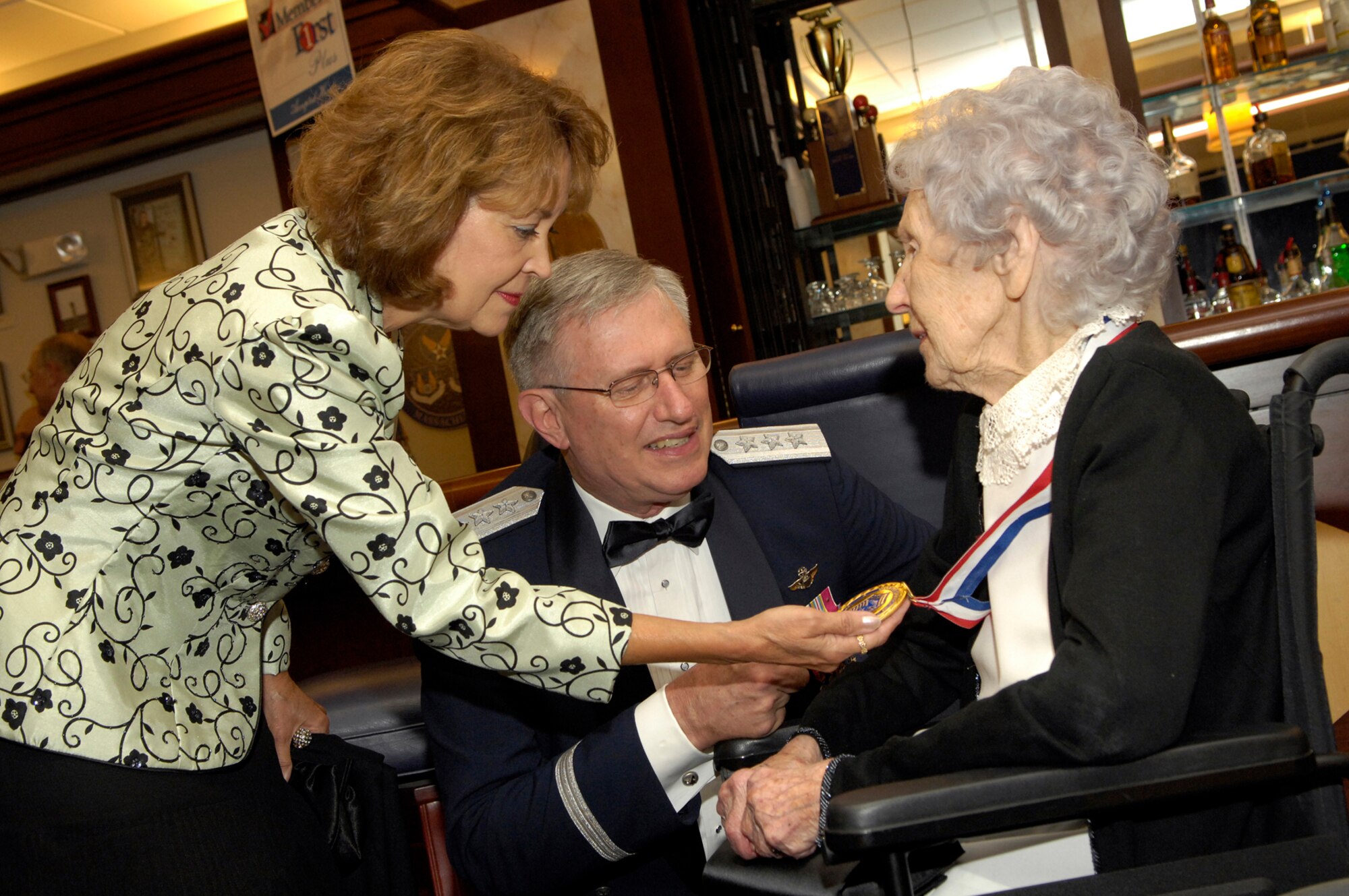 Lieutenant General Roger A. Brady, Air Force Deputy Chief of Staff for Personnel, Headquarters U.S. Air Force, accompanied by his wife, Litha, visit with Chief Master Sgt. Esther MacKay, the oldest living chief master sergeant, during the Air Force’s 60th Anniversary Ball held Friday. General Brady was the guest speaker for the event. (U.S. Air Force photo by Mark Wyatt.)