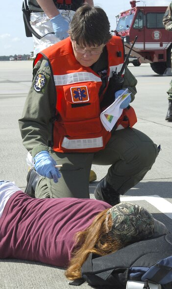 Lt. Col. (Dr.) Elizabeth Lowe, 23rd Medical Group, treats a simulated victim during an exercise Sept. 13. The exercise tested the base's response to emergency situations to prepare for the upcoming air show. (U.S. Air Force photos by Senior Airman Javier Cruz)
