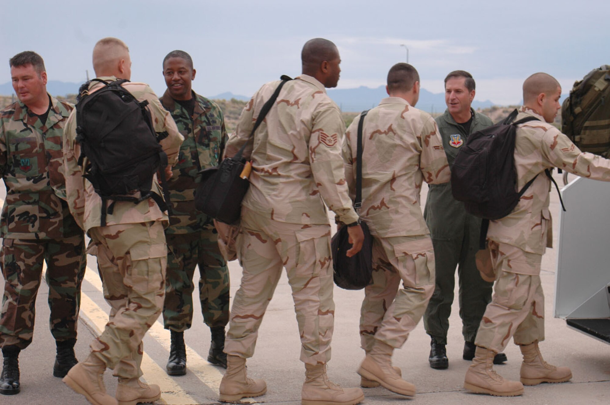 Brig. Gen. David Goldfein, 49th Fighter Wing commander, Chief Master Sgt. Jerome Baker, 49th Communications Squadron, and Master Sgt. Stephen Hampton, 49 CS first sergeant, say goodbye bye to the Airmen who left from Holloman Sept. 17 for Southwest Asia. (U.S. Air Force photo/Airman 1st Class Heather Stanton)