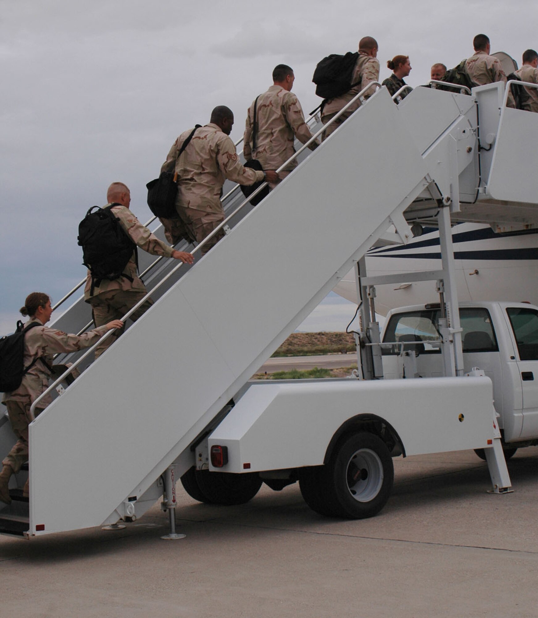 Airman board an airplane to Southwest Asia from Holloman Sept. 17. More than 20 people left in support of the war on terror. (U.S. Air Force photo/Airman 1st Class Heather Stanton)