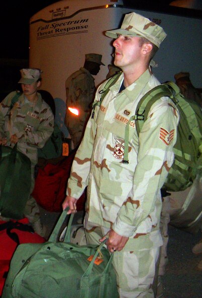 An Airman loads his luggage onto a truck before boarding an airplane to Southwest Asia from Holloman Sept. 17. More than 20 people left in support of the war on terror. (U.S. Air Force photo/Airman 1st Class Heather Stanton)