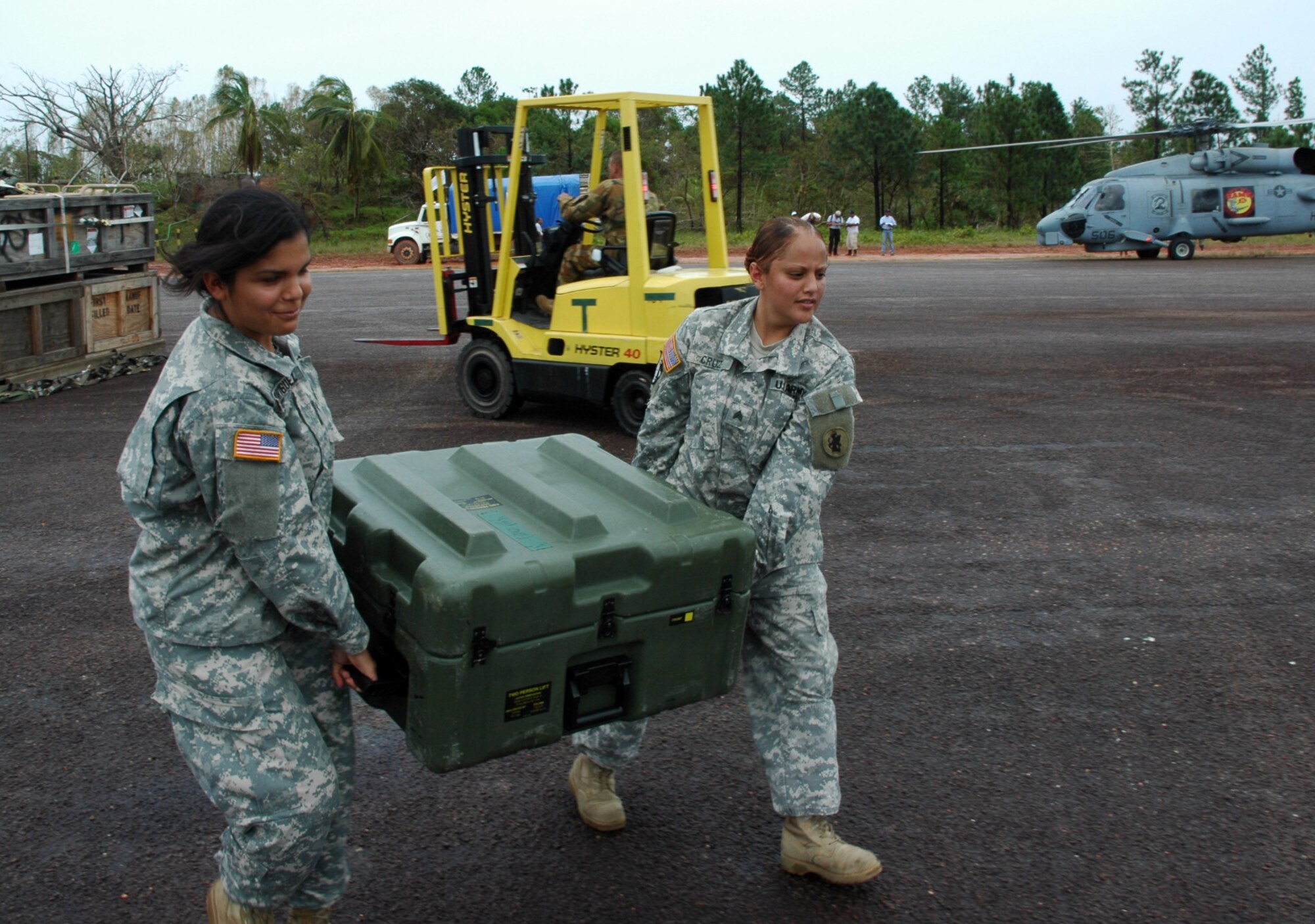 PUERTO CABEZAS, Nicaragua – Specialist Guadalupe Rodriguez and Sgt. Lisena Cruz move equipment to help set up a command and control center here Sept. 15.  Both women are deployed here from Joint Task Force Bravo in Honduras to help support Hurricane Felix relief operations.  The U.S. State Department and Department of Defense are working together to bring food, water and other needed items to small communities on the Nicaraguan coast that were affected by the hurricane.  (Army photo by Specialist Grant Vaught)