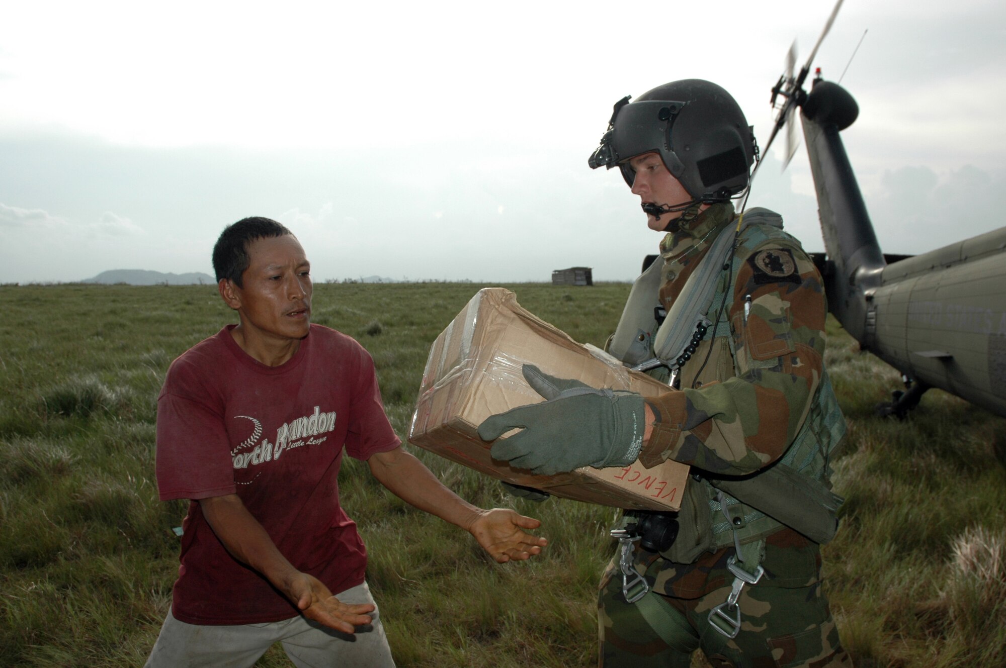PUERTO CABEZAS, Nicaragua – Spc. Lucas Gomez hands a box of food to a local man here Sept. 15.  Specialist Gomez is part of the 1-228th Aviation Battalion deployed to Nicaragua from Soto Cano Air Base in Honduras, to provide relief after Hurricane Felix.  The U.S. State Department and Department of Defense are working together to bring food, water and other needed items to small communities on the Nicaraguan coast that were affected by the hurricane.  (Army photo by Specialist Grant Vaught)