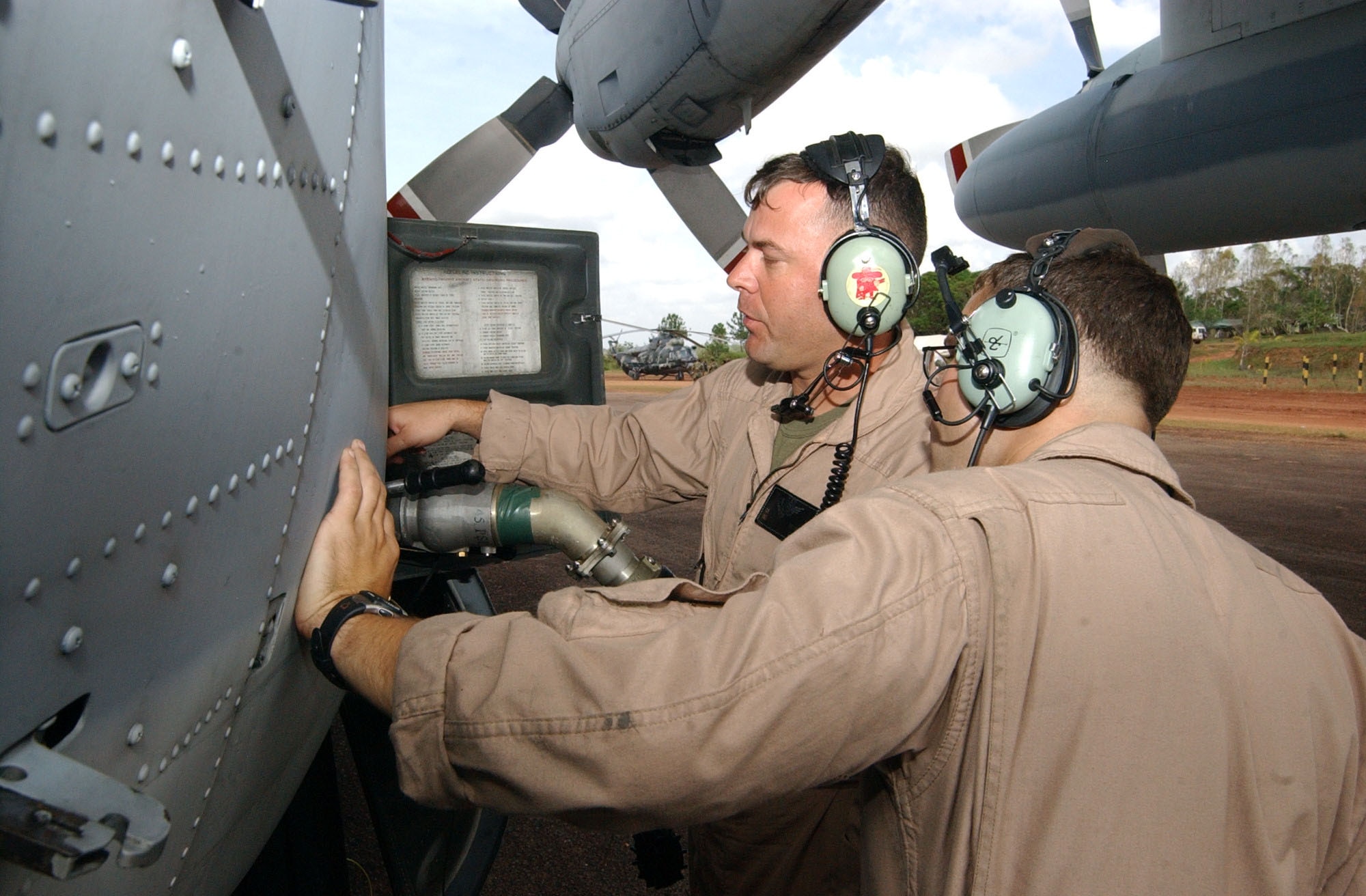 PUERTO CABEZAS, Nicaragua – Marine Staff Sgt. Charles Miller (left) and Marine Corporal Ethan Moore, both assigned to the Marine Aerial Refueler Transport Squadron 452 (VMGR-452), connect a fuel hose to a KC-130 here Sept. 15.  The KC-130 pumped 3,500 gallons of jet fuel into an Advanced Aviation Forward Area Refueling System here that was set up by soldiers from the 1st Battalion, 228th Aviation Regiment from Joint Task Force-Bravo at Soto Cano Air Base, Honduras, to support aircraft flying relief missions following Hurricane Felix.  (U.S. Air Force photo by Tech. Sgt. Sonny Cohrs)