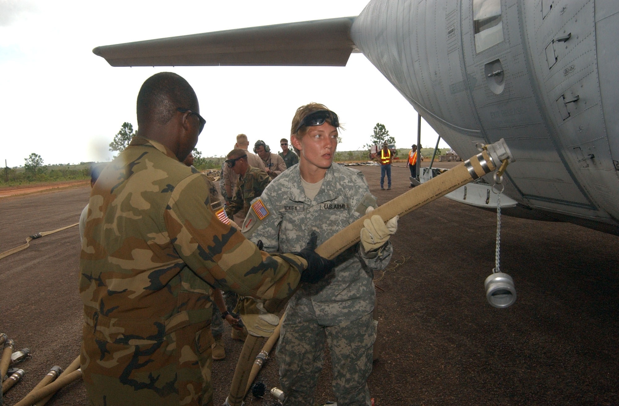 PUERTO CABEZAS, Nicaragua – Army Sergeants Andrea Dickey (right) and Victor Flores, both assigned to Joint Task Force-Bravo at Soto Cano Air Base, Honduras, affix a refueling hose to a U.S. Marine Corps KC-130 assigned to the Marine Aerial Refueler Transport Squadron 452 (VMGR-452).  The KC-130 pumped 3,500 gallons of jet fuel into an Advanced Aviation Forward Area Refueling System here to support hurricane relief missions following landfall of Hurricane Felix. (U.S. Air Force photo by Tech. Sgt. Sonny Cohrs)