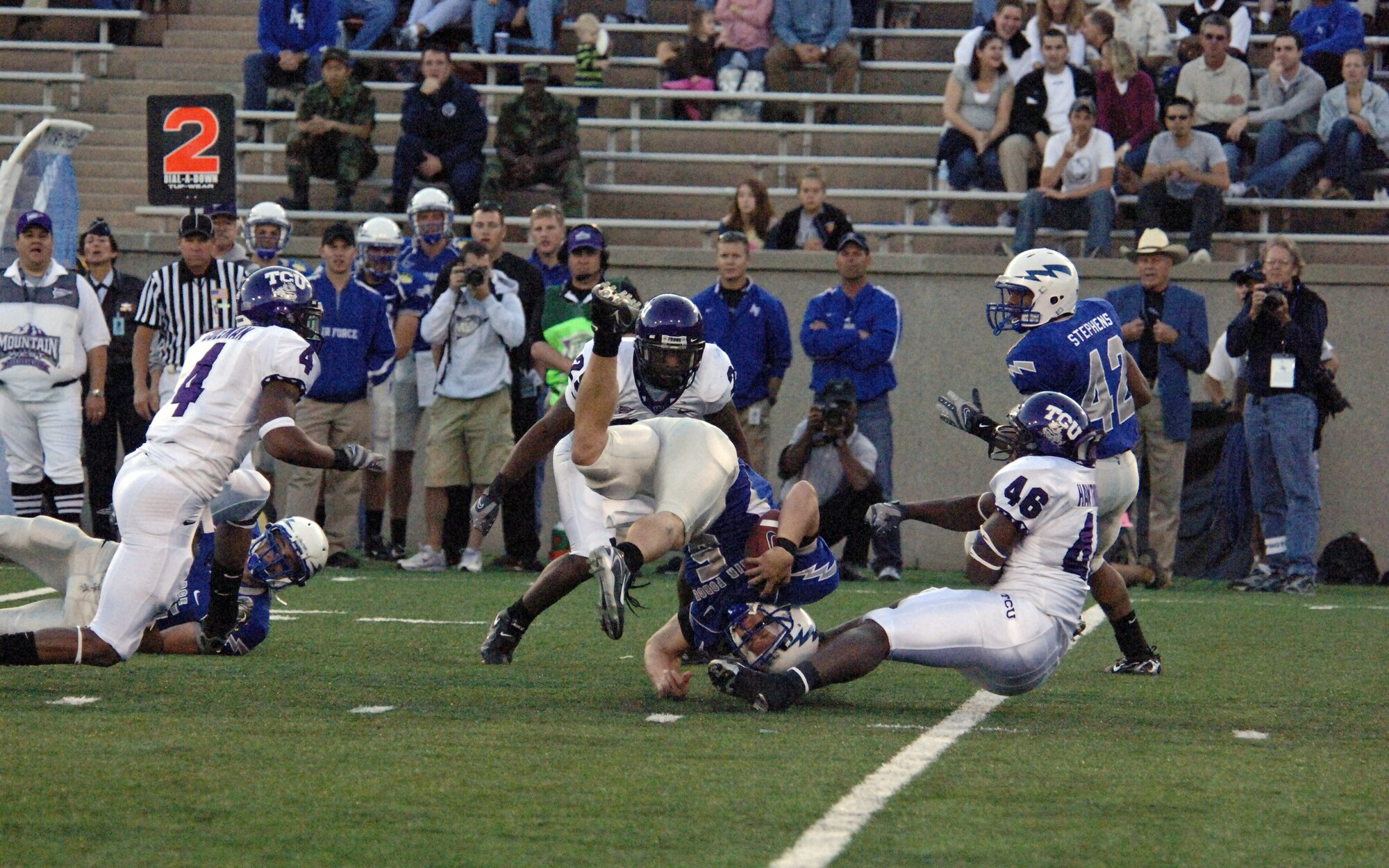 Falcon quarterback Shaun Carney gets flipped between TCU defenders David Hawthorne, 46, and Stephen Hodge, 29, Sept. 13 at Falcon Stadium at the U.S. Air Force Academy. Despite getting sacked four times, Carney and company recovered to edge the Horned Frogs, 20-17, in overtime. (U.S. Air Force photo/John Van Winkle)     