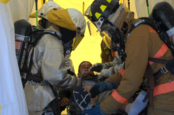 WHITEMAN AIR FORCE BASE, Mo. -- Firefighters decontaminate Airman 1st Class John Henry, 509th Operations Support Squadron, at Ike Skelton Park Sept 12. Airman Henry was affected by chemicals during the exercise. (U.S. Air Force photo/Airman First Class Cory Todd)
