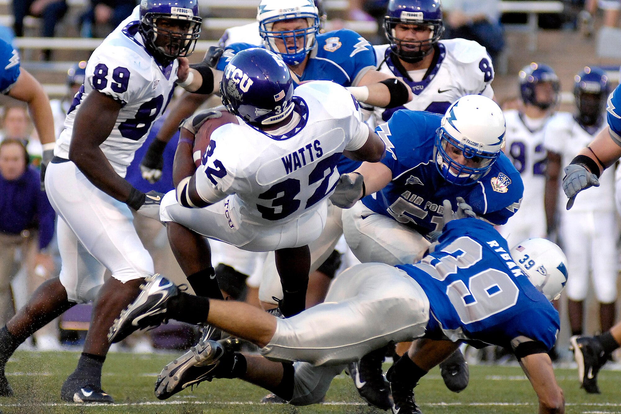 TCU tailback Justin Watts is spun around by Air Force cornerback Garrett Rybak Sept. 13 in Falcon Stadium as Falcon linebacker Aaron Shanor closes in. The Air Force defense limited the Horned Frogs to 89 yards rushing in 32 attempts in the bluesuiters 20-17 overtime win. (U.S. Air Force photo/Dennis Rogers)