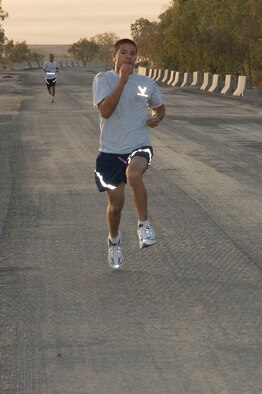 Senior Airman Mark Gothel crosses the finish line with a time of 1 hour, 32 minutes, to take first place in a half marathon here Sept. 15.  Airman Gothel is deployed to the 386th Air Expeditionary Wing from the 193rd Special Operations Wing, Middletown, Penn.  (U.S. Air Force photo Staff Sgt. Tia Schroeder) 