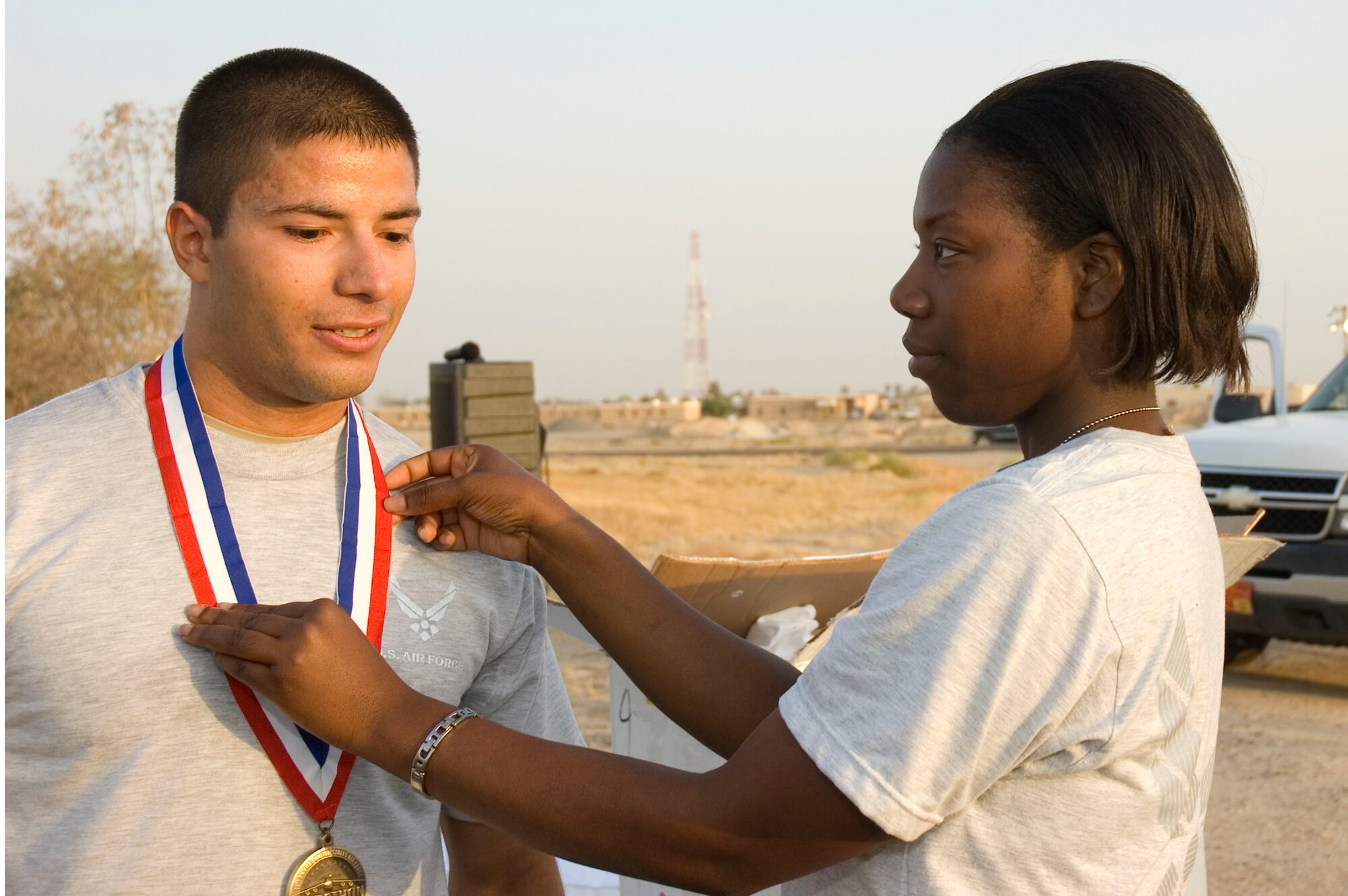 Senior Airman Mark Gothel receives his medal after finishing first with a record time of 1 hour, 32 minutes in a half marathon here Sept. 15.  Airman Gothel is deployed to the 386th Air Expeditionary Wing from the 193rd Special Operations Wing, Middletown,  Penn.  (U.S. Air Force photo Staff Sgt. Tia Schroeder) 
