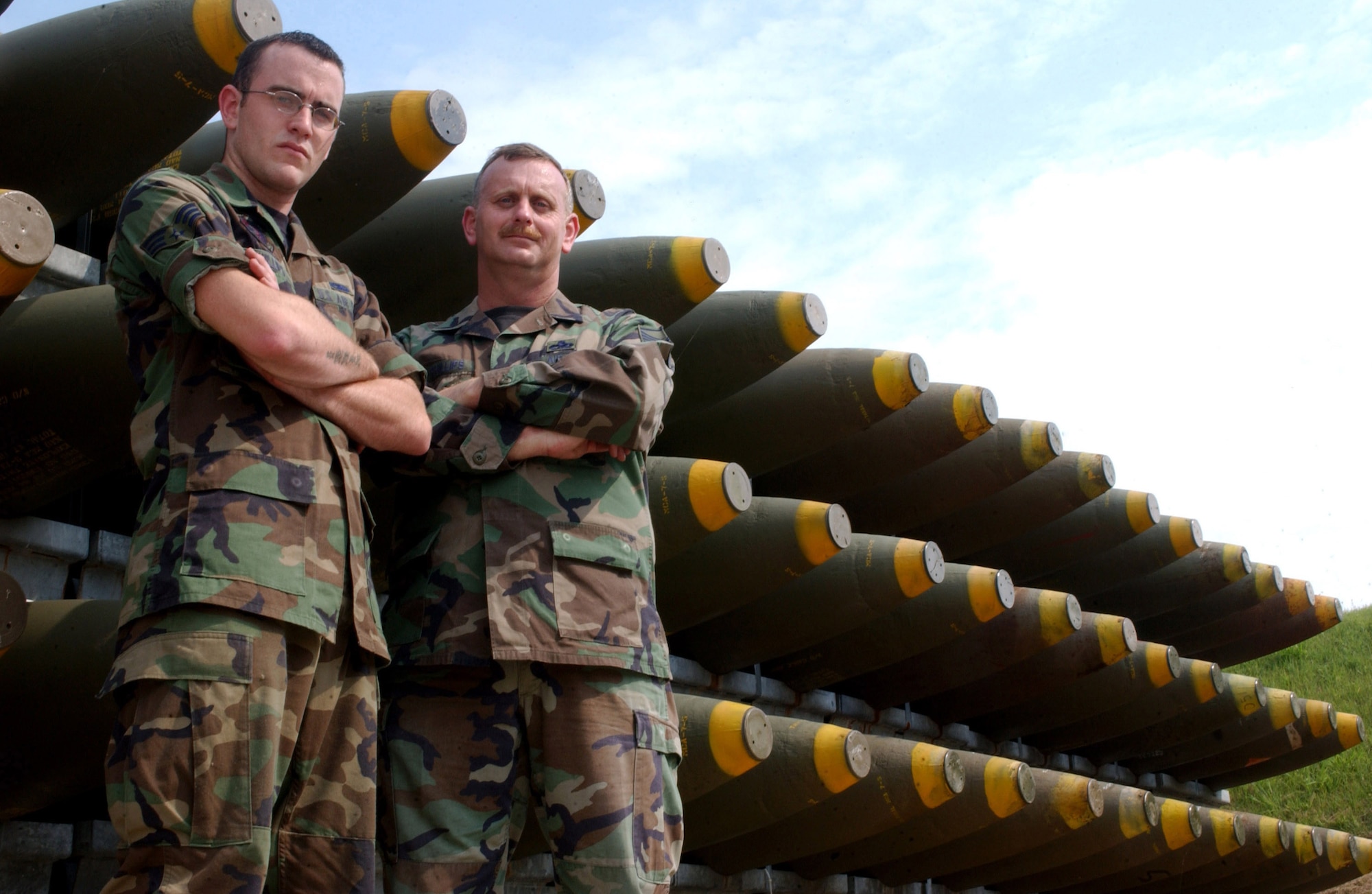 KUNSAN AIR BASE, South Korea -- Senior Airman David Phillips (left) and his father Master Sgt. Torre Phillips, deployed here with the 555th Expeditionary Fighter Squadron "Triple Nickel" from Aviano AB, Italy, work hand-in-hand to ensure 8th Fighter Wing "Wolf Pack" munitions are ready to go at a moment's notice. Sergeant Phillips is deployed here in support of a four-month air expeditionary force rotation while his son completes a one-year remote tour here. Airman Phillips is assigned to the 8th Maintenance Squadron here. (U.S. Air Force photo/Senior Airman Steven Doty)                               