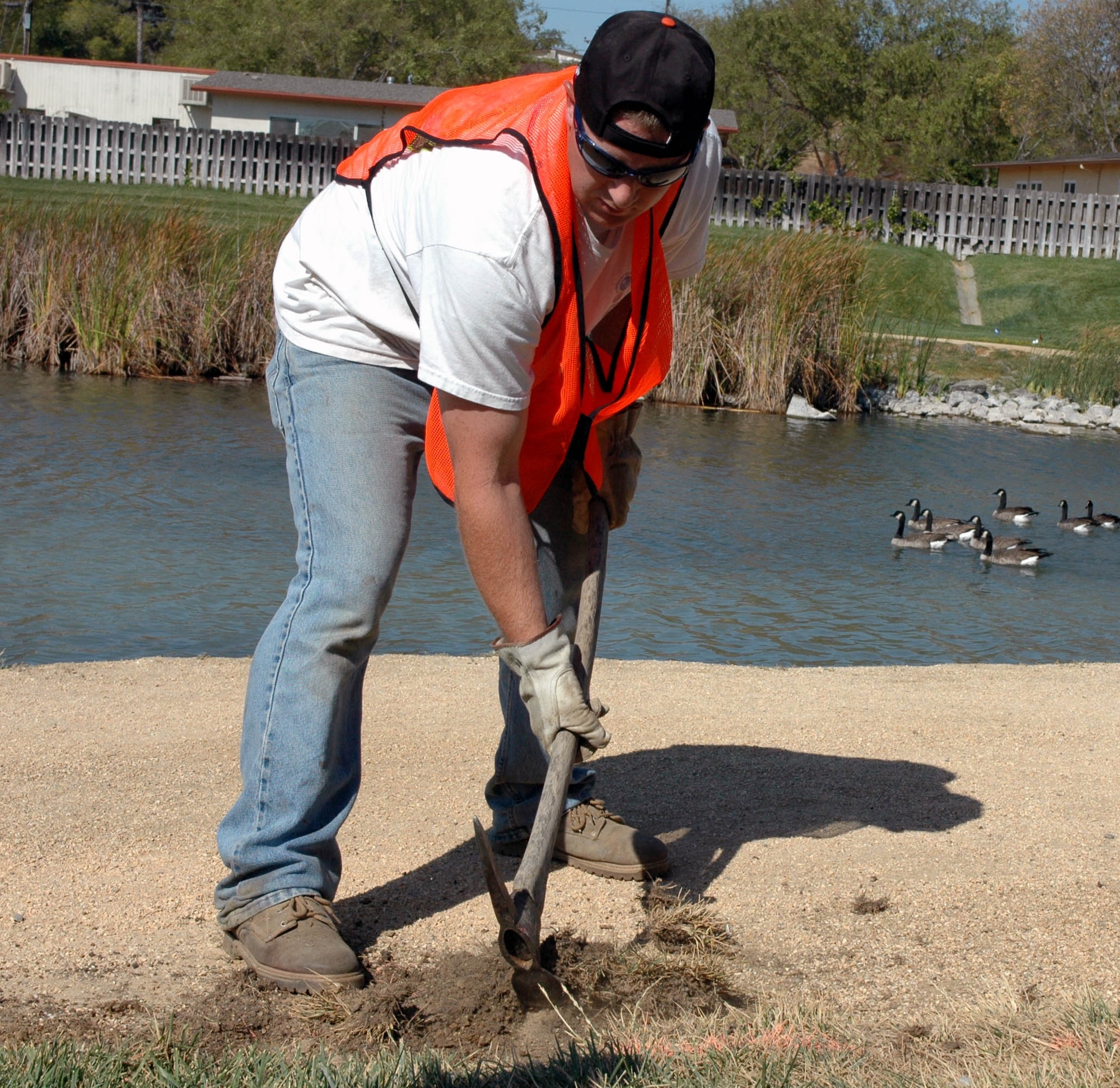 Dan Postak, Gentry Construction, performs repairs on the Duck Pond jogging trail Sept. 13. Portions of the Duck Pond are closed through mid-November in order to allow construction crews to repair and replace decomposed granite that is causing erosion of the trail. (U.S. Air Force photo/Staff Sgt. Matthew McGovern)