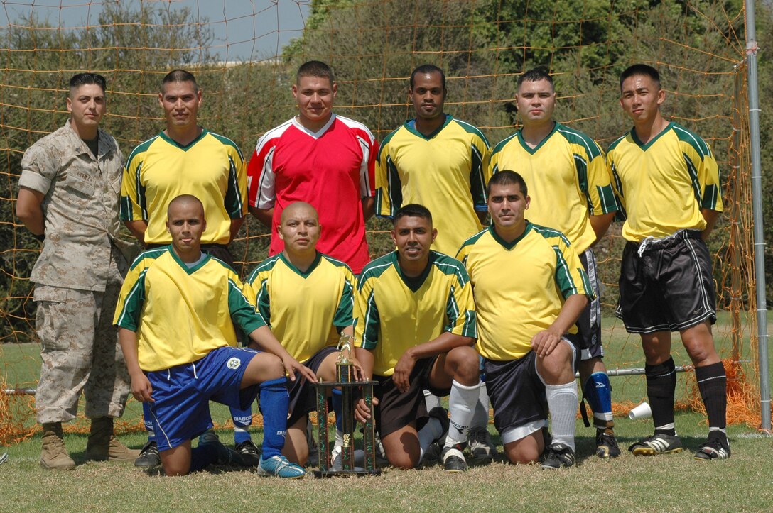 Consolidated Personnel Administration Center soccer players pose under the goal net after winning the Commanding General?s Cup soccer championship. In the final game, CPAC beat Support Bn. 6-2.