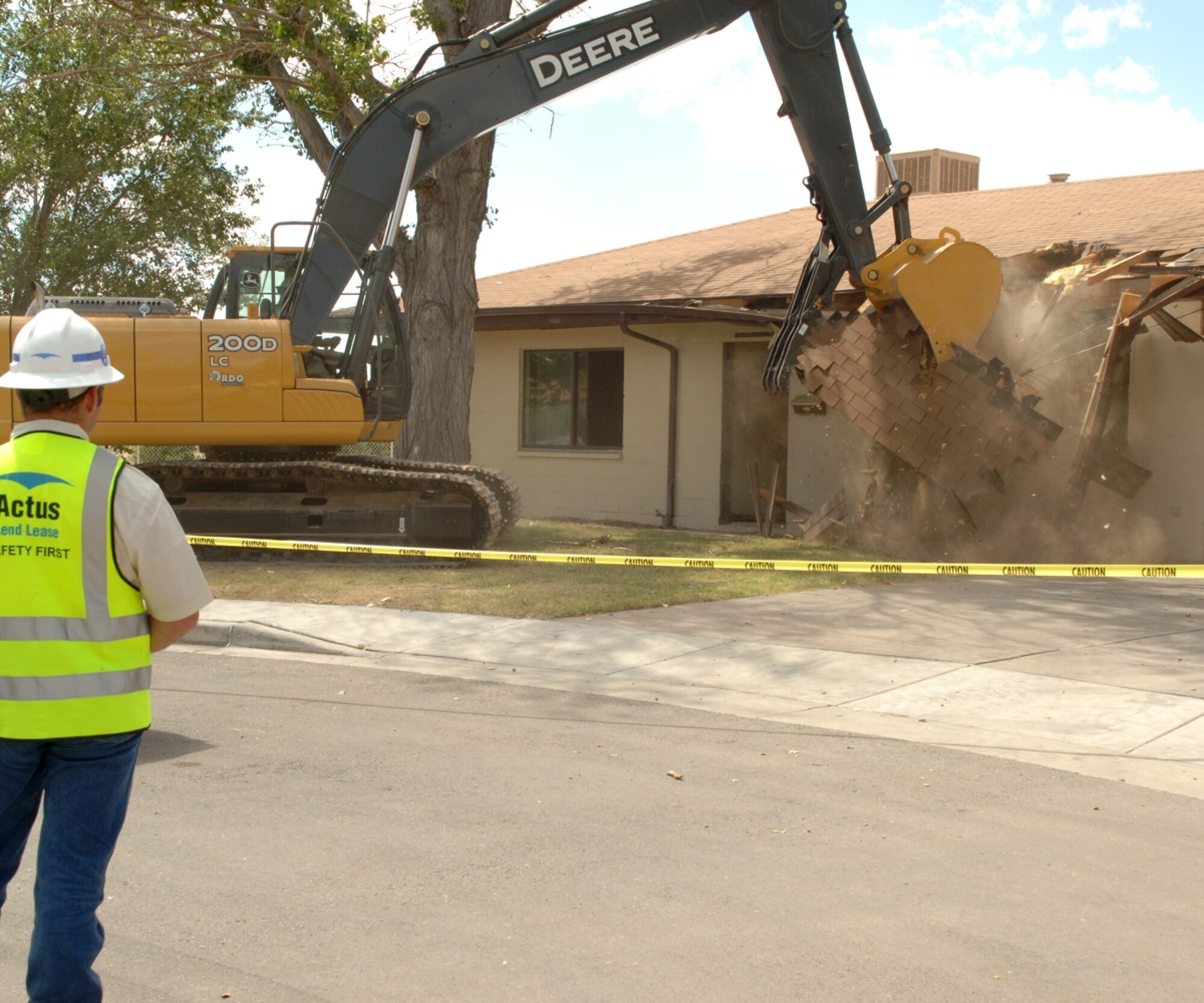 The first house on Holloman is demolished by a bulldozer Sept. 18 at the groundbreaking ceremony. The houses should be finished September 2008. (U.S. Air Force photo/Airman 1st Class Tiffany Trojca)