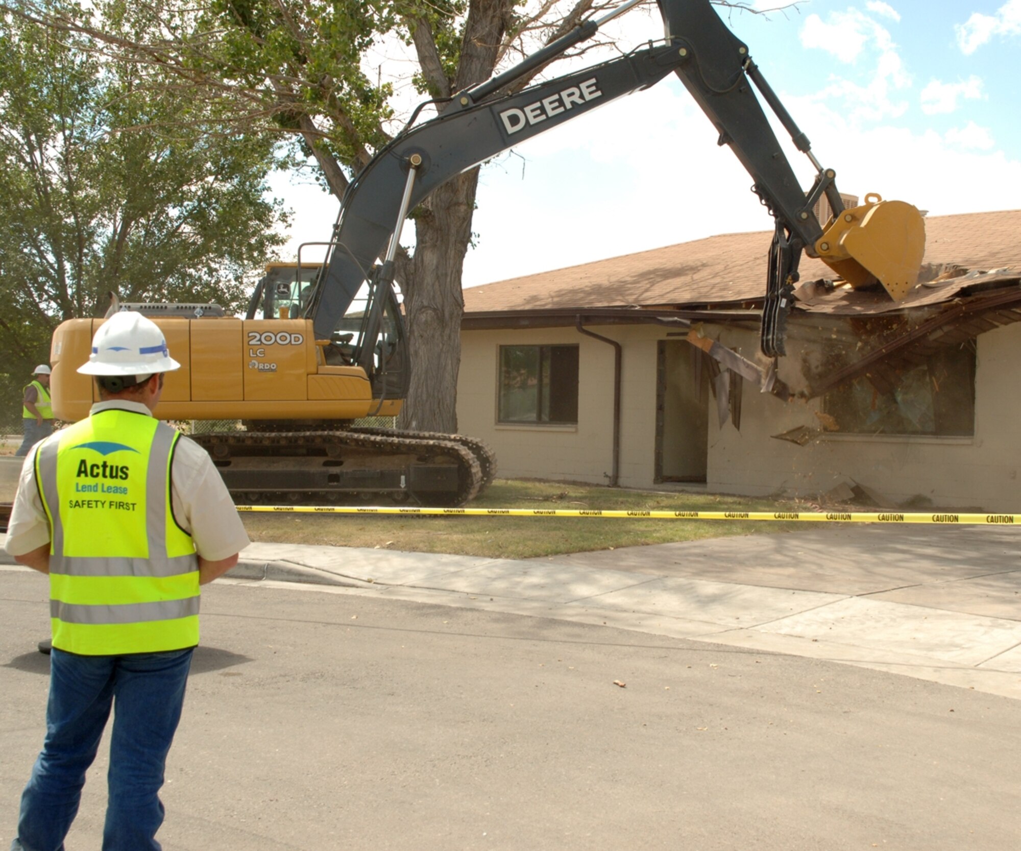 The first house on Holloman is demolished by a bulldozer Sept. 18 at the groundbreaking ceremony. The houses should be finished September 2008. (U.S. Air Force photo/Airman 1st Class Tiffany Trojca)