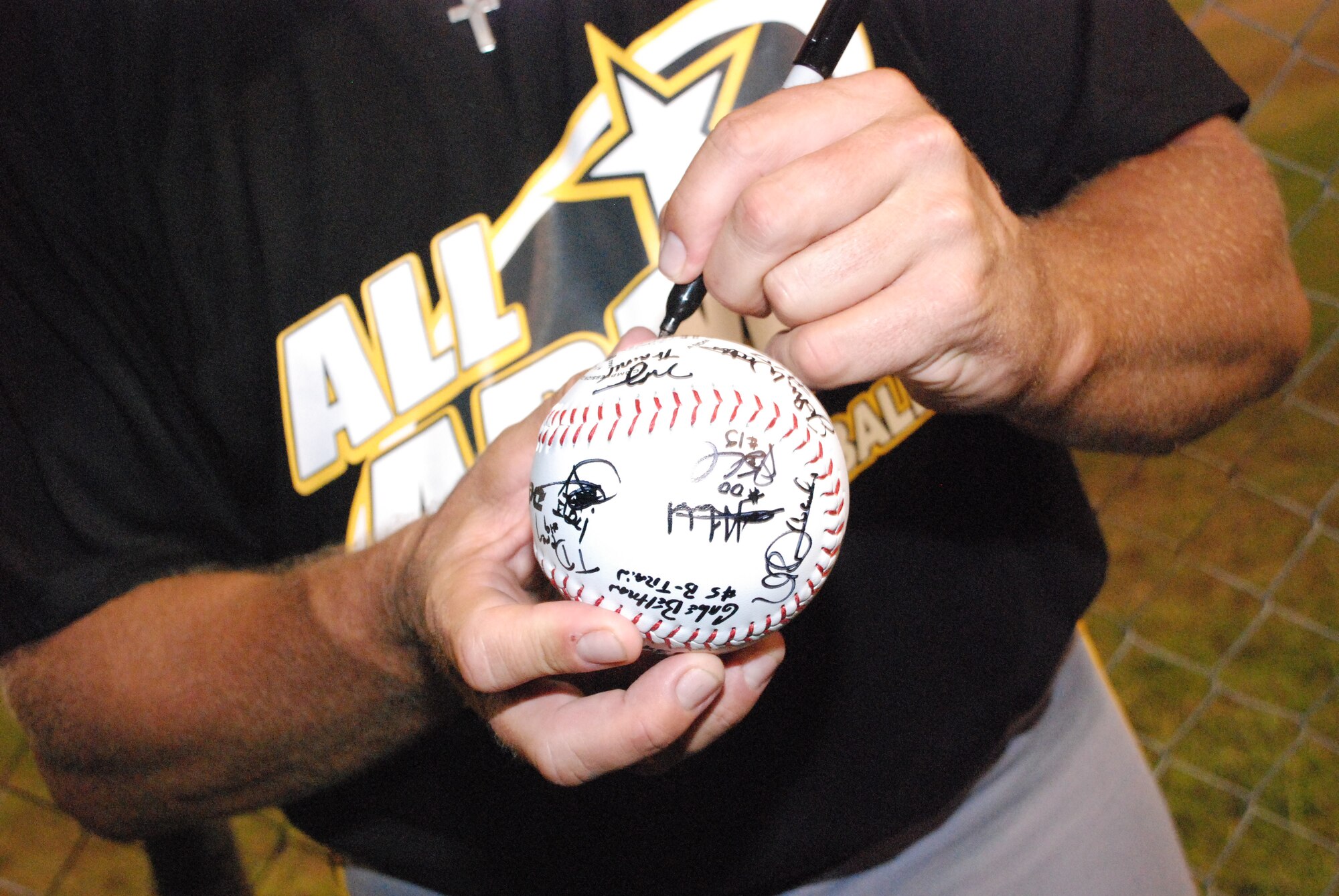 EGLIN AIR FORCE BASE, Fla. -- The all-Army team signs softballs for each other in regognition of thier gold medal victory at the 2007 U.S. Armed Forces Men's Softball Championship tournament, featuring the best players from the U.S. Air Force, U.S. Army, U.S. Marine Corps and the U.S. Navy. The tournament was a round-robin with a total of nine games Sept. 12 - 14 at Foster Stadium here. The all-Army team claimed the gold medal while the Marine Corps sqeauked past the Air Force for the Silver. The all-Air Force team has won three championships in a row from 2004-2006 and four out of the last five. The all-Army team won it in 2003. (U.S Air Force photo by Staff Sgt. Mike Meares)