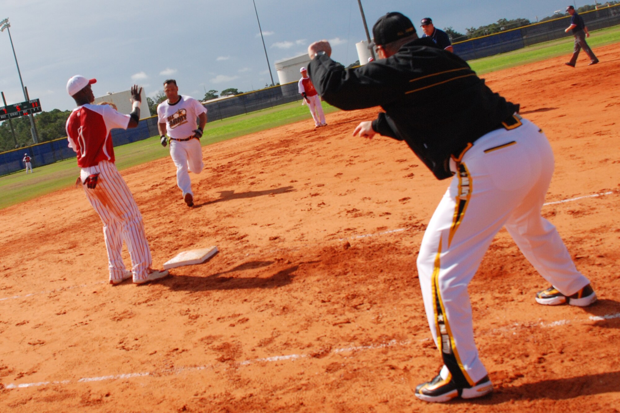 EGLIN AIR FORCE BASE, Fla. -- Victor Rivera-Collazo, all-Armey team coach, stops a base runner at thrid base during tournament playagainst the Marine Corps. The 2007 U.S. Armed Forces Men's Softball Championship tournament, featuring the best players from the U.S. Air Force, U.S. Army, U.S. Marine Corps and the U.S. Navy, played the round-robin tournament Sept. 12 - 14 at Foster Stadium here. The all-Army team claimed the gold medal while the Marine Corps sqeauked past the Air Force for the Silver. The all-Air Force team has won three championships in a row from 2004-2006 and four out of the last five. The all-Army team won it in 2003. (U.S Air Force photo by Staff Sgt. Mike Meares)